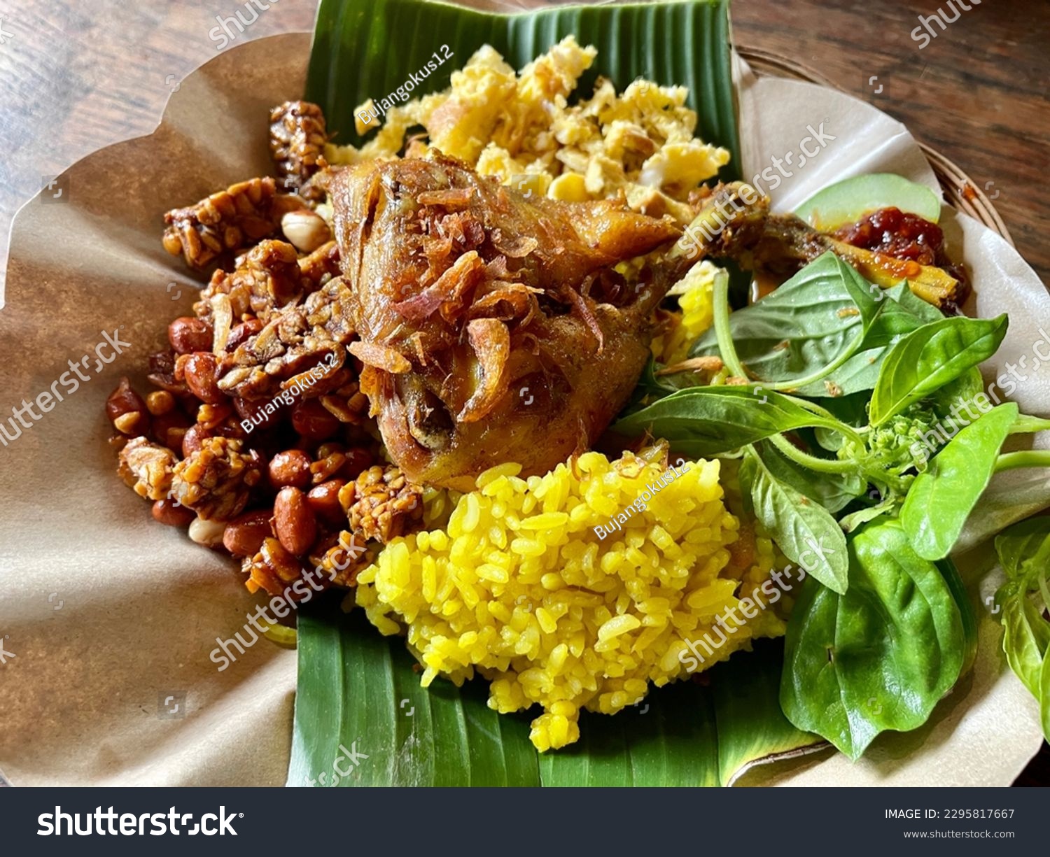 Yellow Rice (Nasi Kuning). This traditional Indonesian dish consists of rice cooked in coconut milk that is usually seasoned with turmeric, lemongrass, and kaffir lime leaves. #2295817667