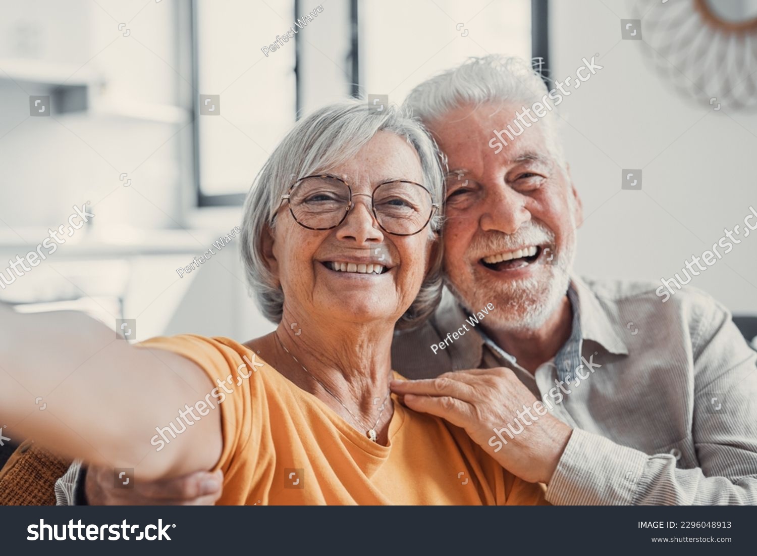 Head shot portrait happy senior couple taking selfie, having fun with phone cam, smiling aged wife and husband hugging, looking at camera, posing for photo, aged man vlogger recording video #2296048913