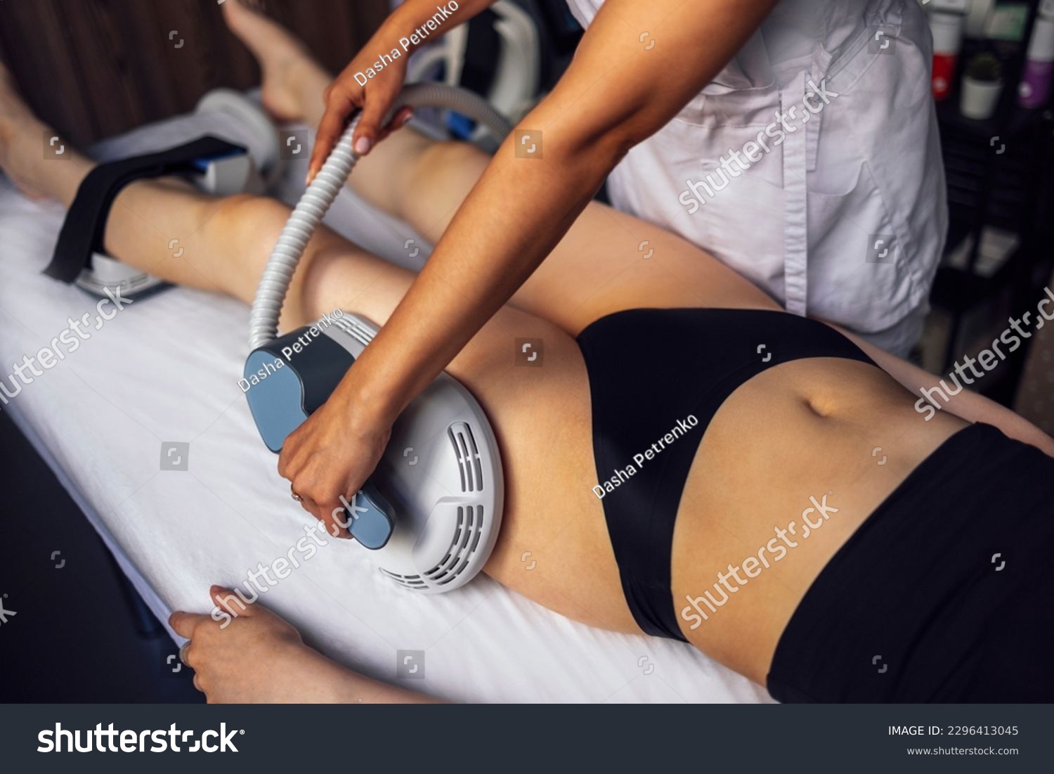 Woman getting treatment on buttocks to burn fat, build muscles and remove cellulite. Professional beauty salon #2296413045