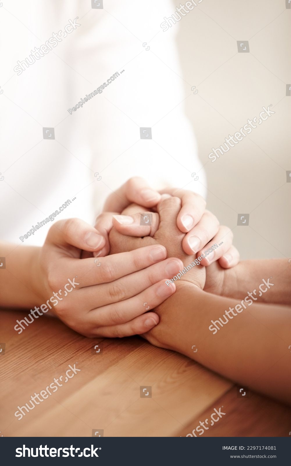 Empathy, love and spiritual with people holding hands in comfort, care or to console each other. Trust, help or support with friends praying together during depression, anxiety or the pain of loss #2297174081