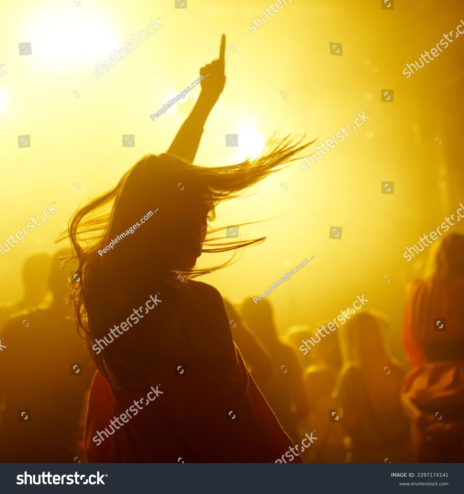 Dance, rave and female person at a concert, disco event or psychedelic trance festival. Night, energy and woman dancing or moving to a song with a yellow light at techno night club or party with dj. #2297174141