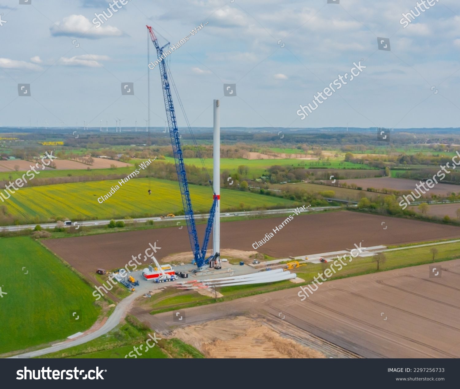 Construction of a wind turbine with a blue crawler crane #2297256733