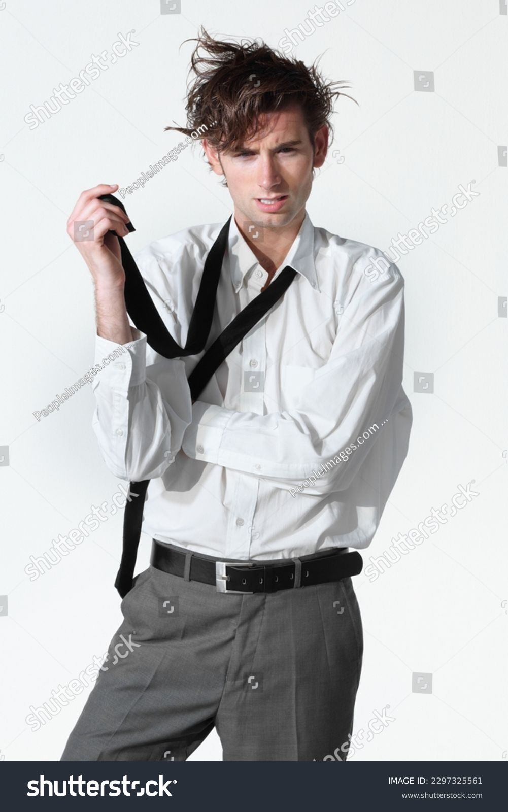 Hes lost his mind. A disheveled young businessman isolated on a white background. #2297325561