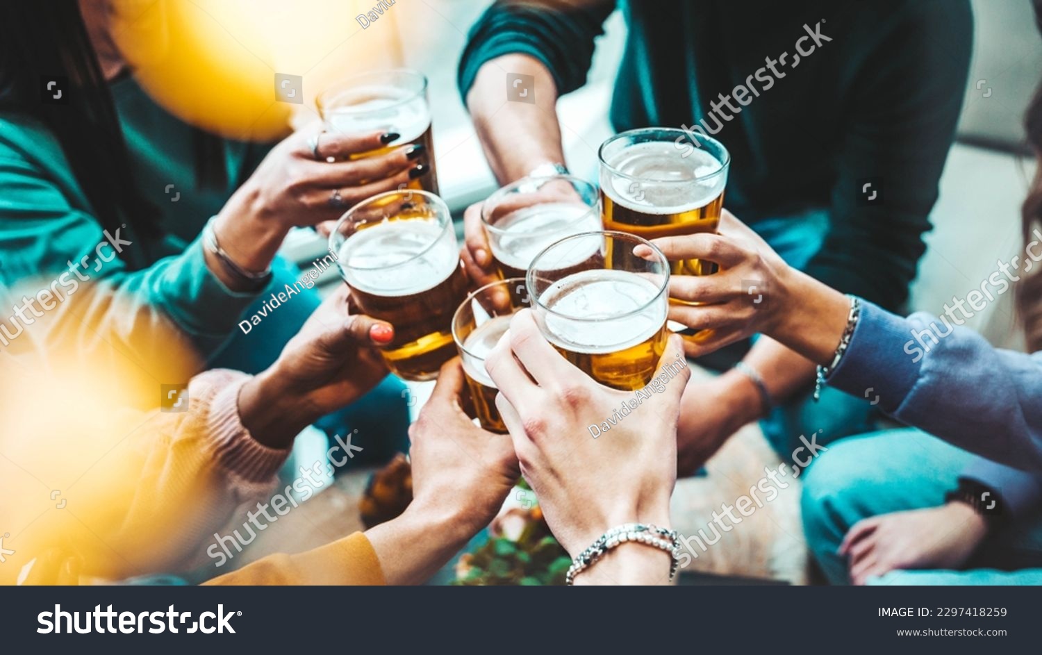 Group of people drinking beer at brewery pub restaurant - Happy friends enjoying happy hour sitting at bar table - Closeup image of brew glasses - Food and beverage lifestyle concept #2297418259