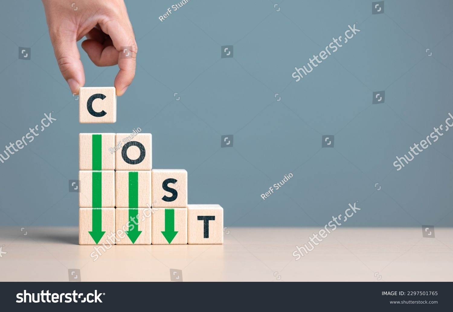 Lean or Cost reduction concept. Optimize manufacturing management. Decreasing company expense to maximize profits. Hand puts wooden cube with words cost and green down arrows. Business improvement. #2297501765