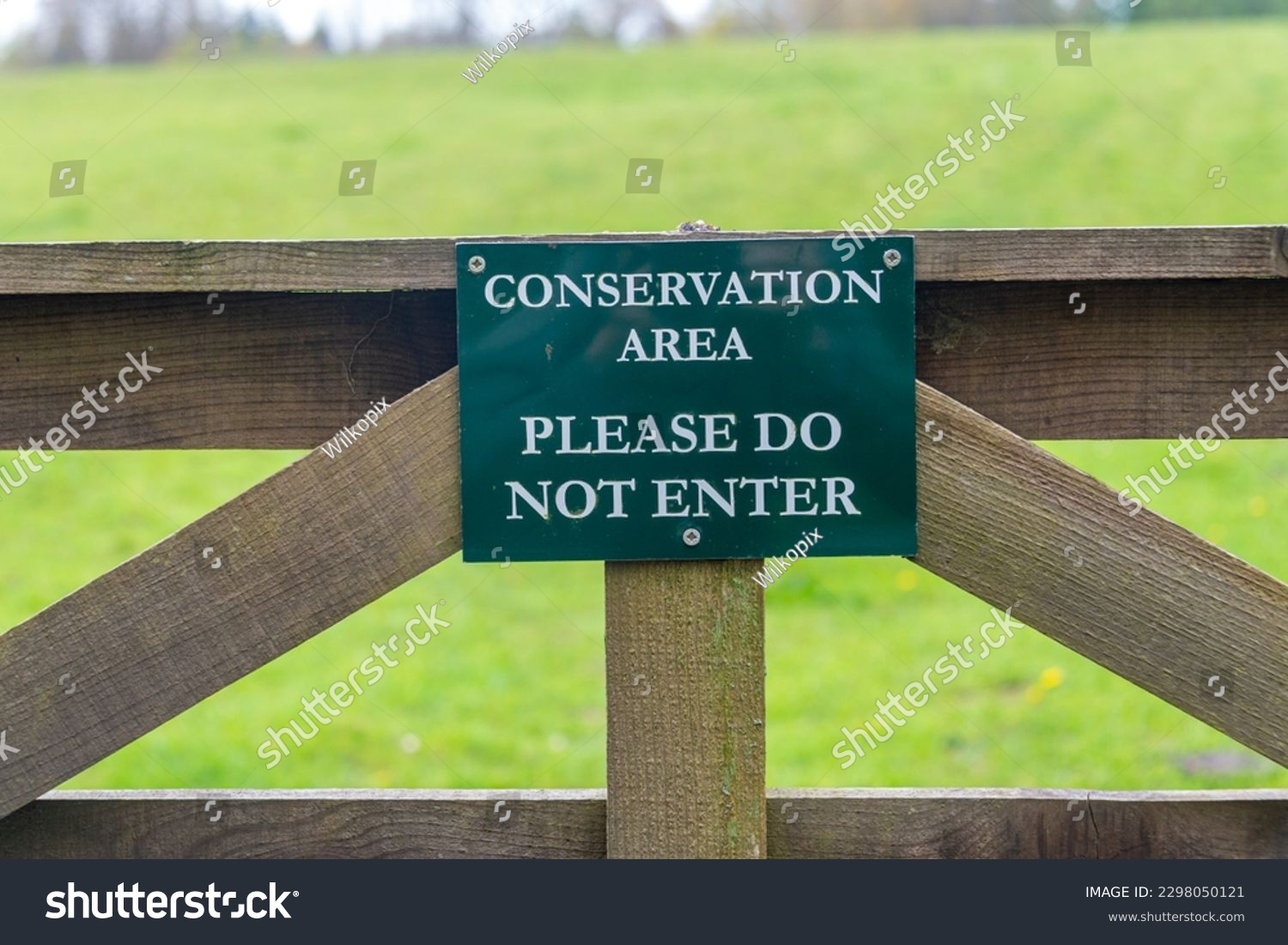 Conservation area, please do not enter sign on a wooden gate. #2298050121