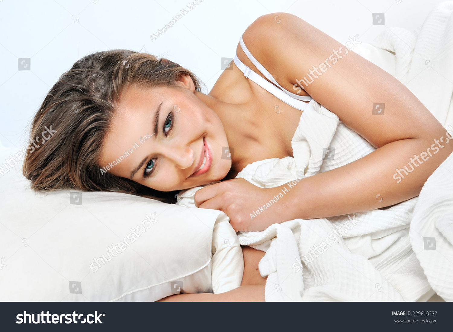 Pretty woman lying down on her bed at home waking up in the morning #229810777