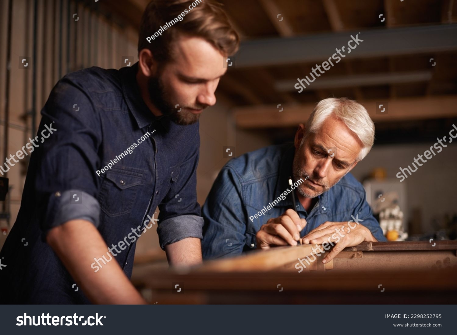 Artisans at work. a father showing his son the tricks of the building trade. #2298252795