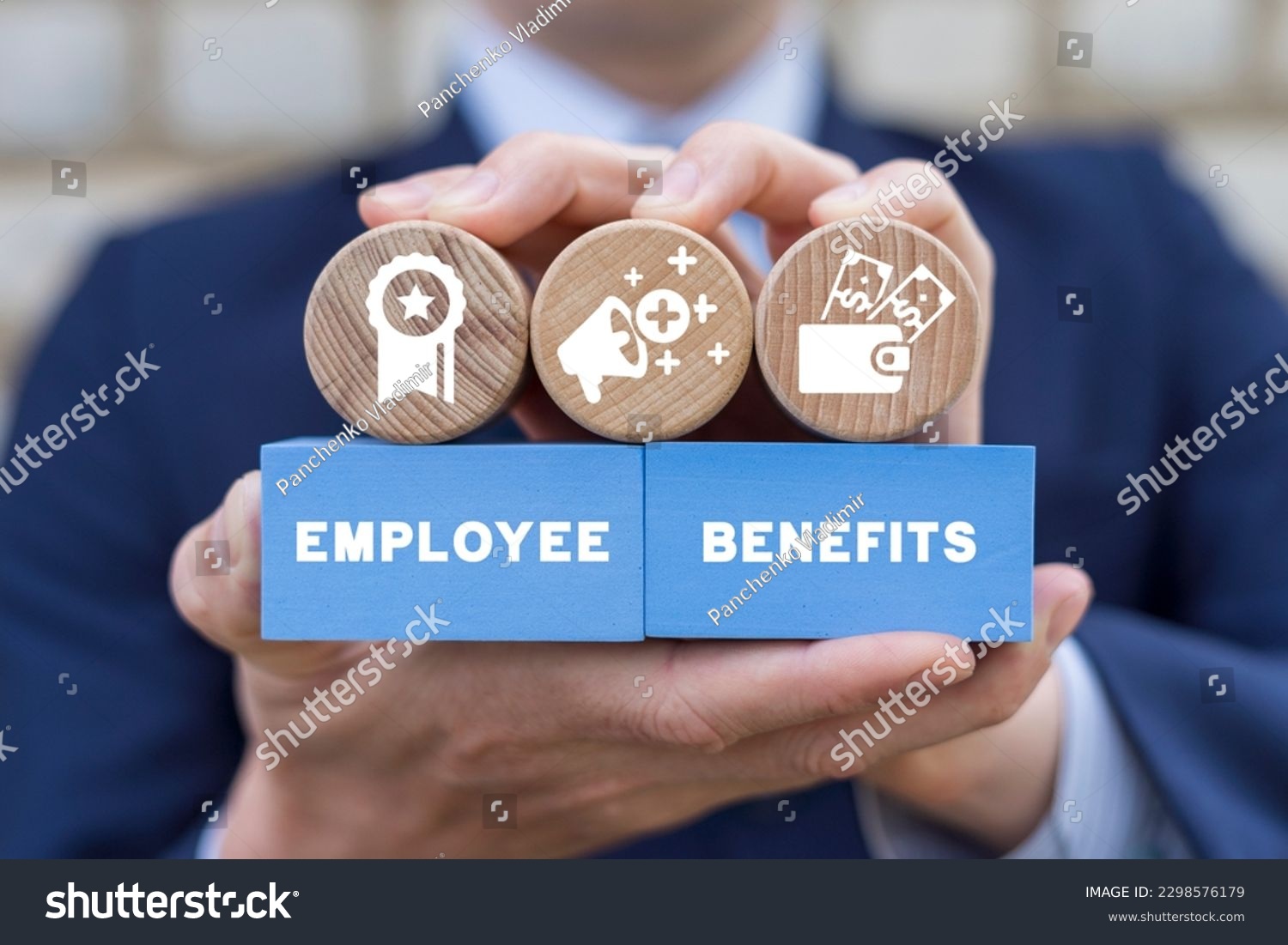 Businessman holding colorful blocks with icons and inscription: EMPLOYEE BENEFITS. Concept of Employee Benefits Career. Business Bonus Work Perks. #2298576179