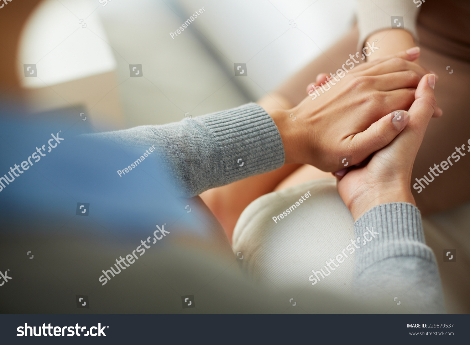 Close-up of psychiatrist hands together holding palm of her patient #229879537