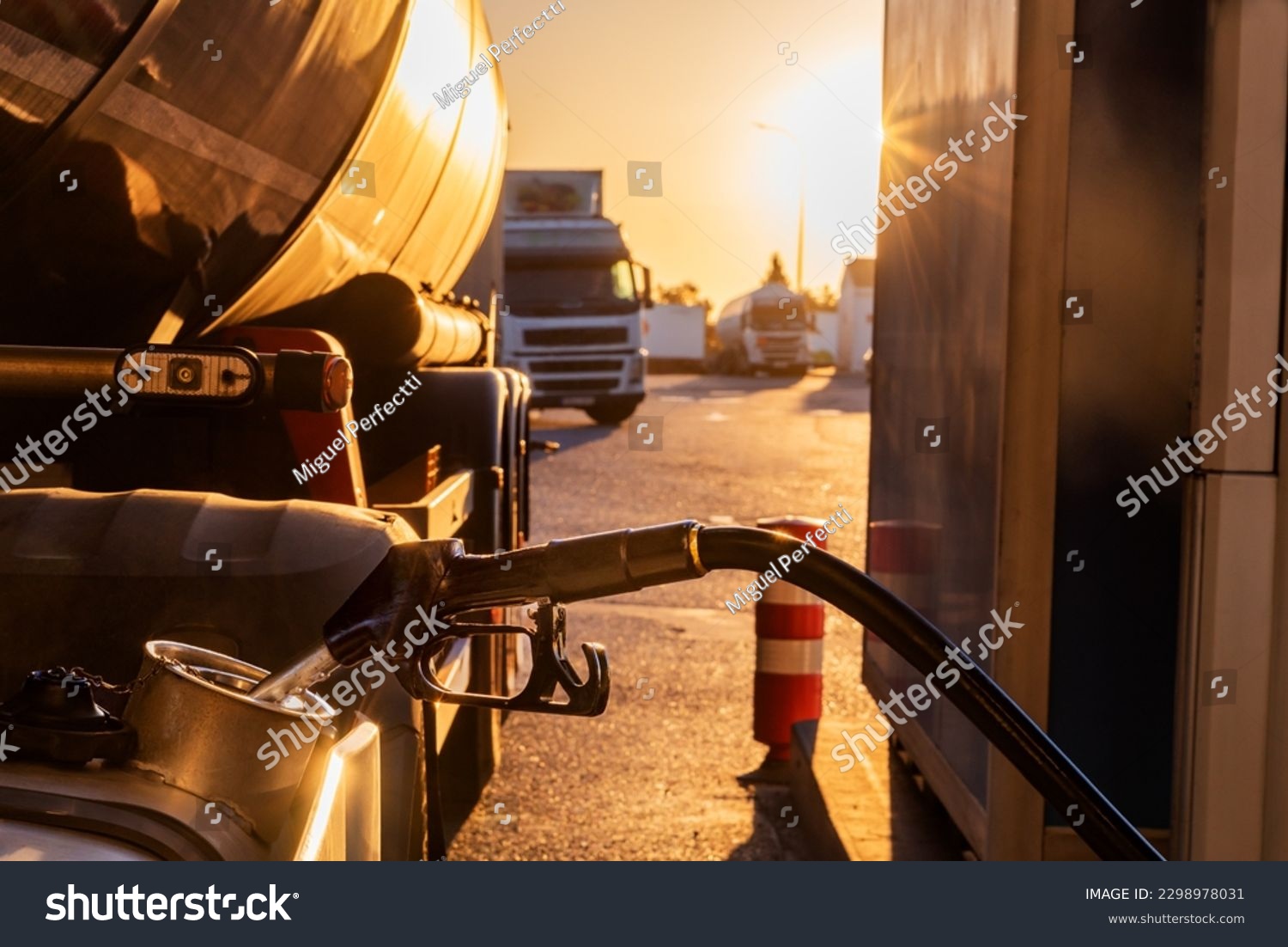 Filling the fuel tank of a truck at a gas station. #2298978031
