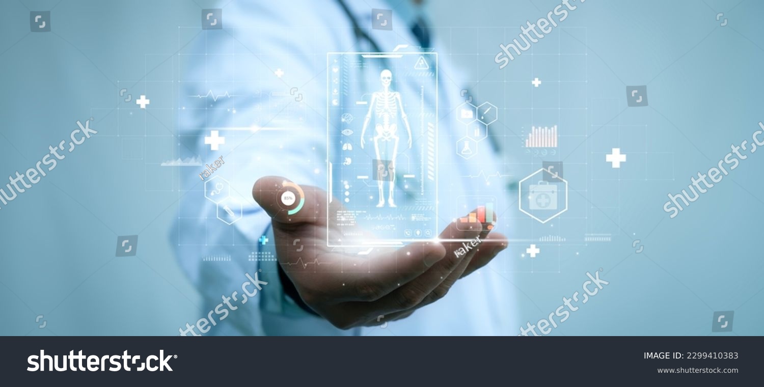 A medical worker holding virtual hologram of human skeleton in his hand on with analysis of human organ with x-ray scanner, Hi-tech technology and medical of the future concept #2299410383