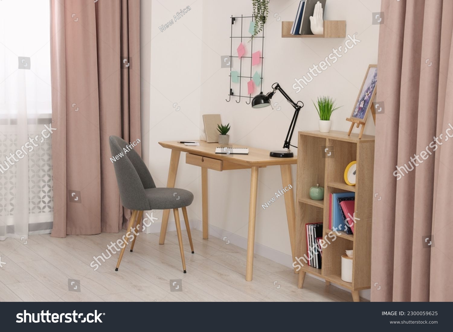 Stylish workplace with wooden desk, chair and lamp in room. Interior design #2300059625