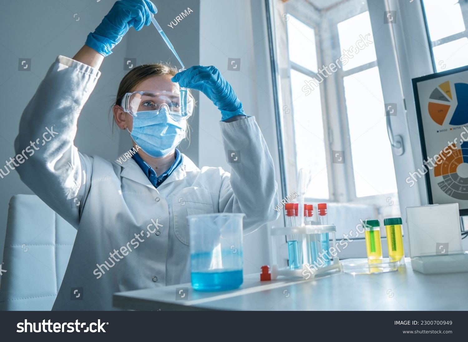 Scientist, chemist conducting an experiment on the synthesis of a new pharmaceutical drug in the laboratory. Research in a medical laboratory to identify new ways to diagnose and treat cancer. #2300700949