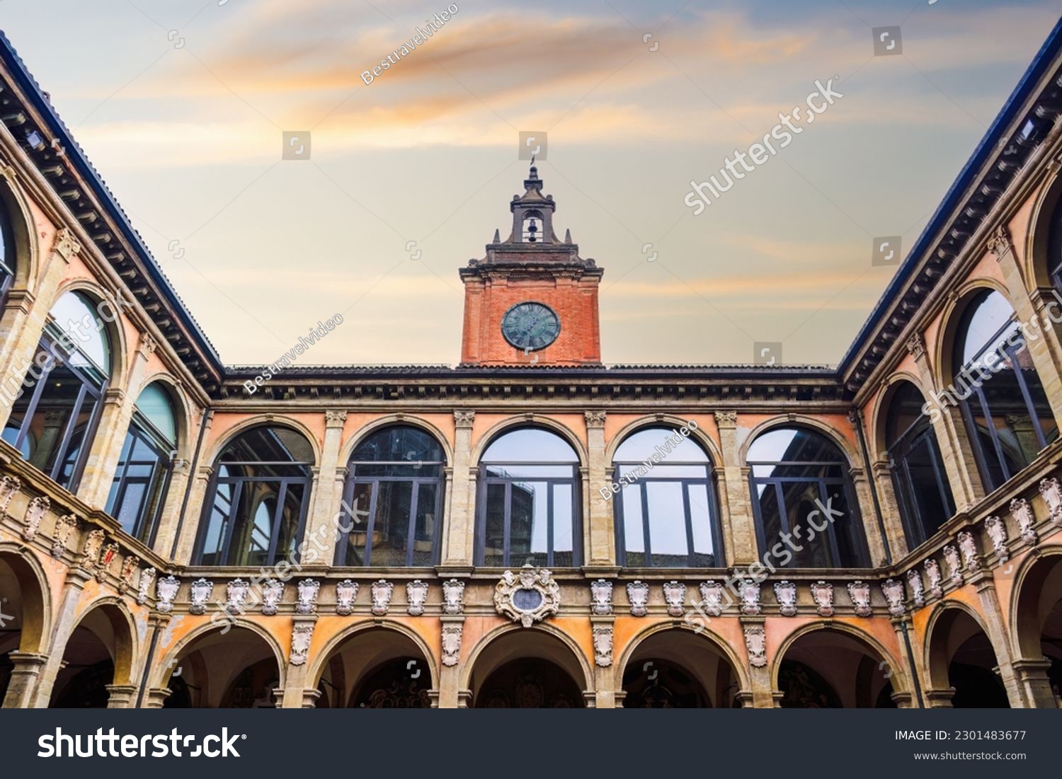 Bologna, Italy Biblioteca Comunale dell'Archiginnasio courtyard with clock tower against sky. #2301483677