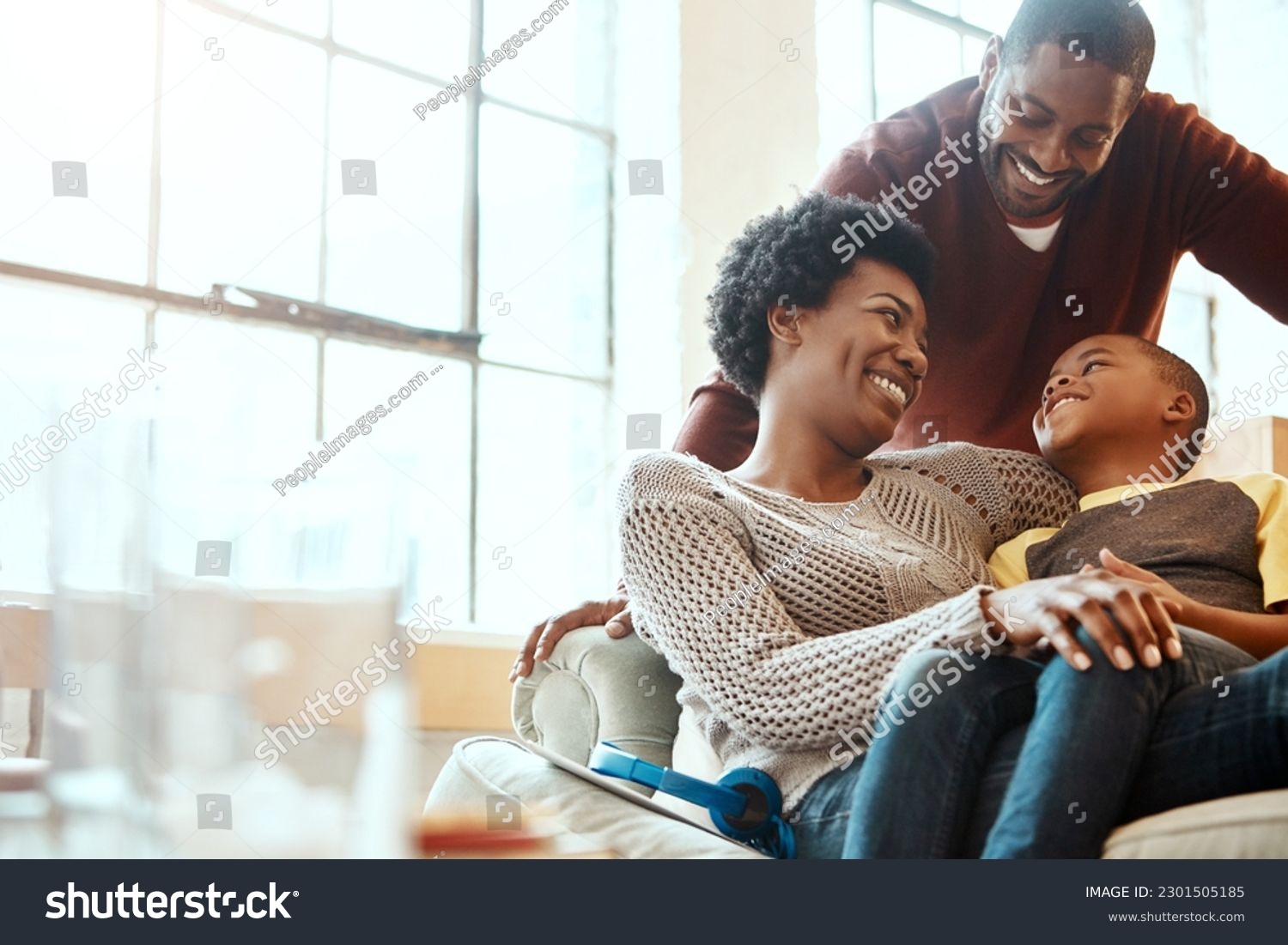 Happy, love and family bonding on a sofa together in the living room of their modern house. Happiness, smile and African parents spending quality time, talking and relaxing with her boy child at home #2301505185