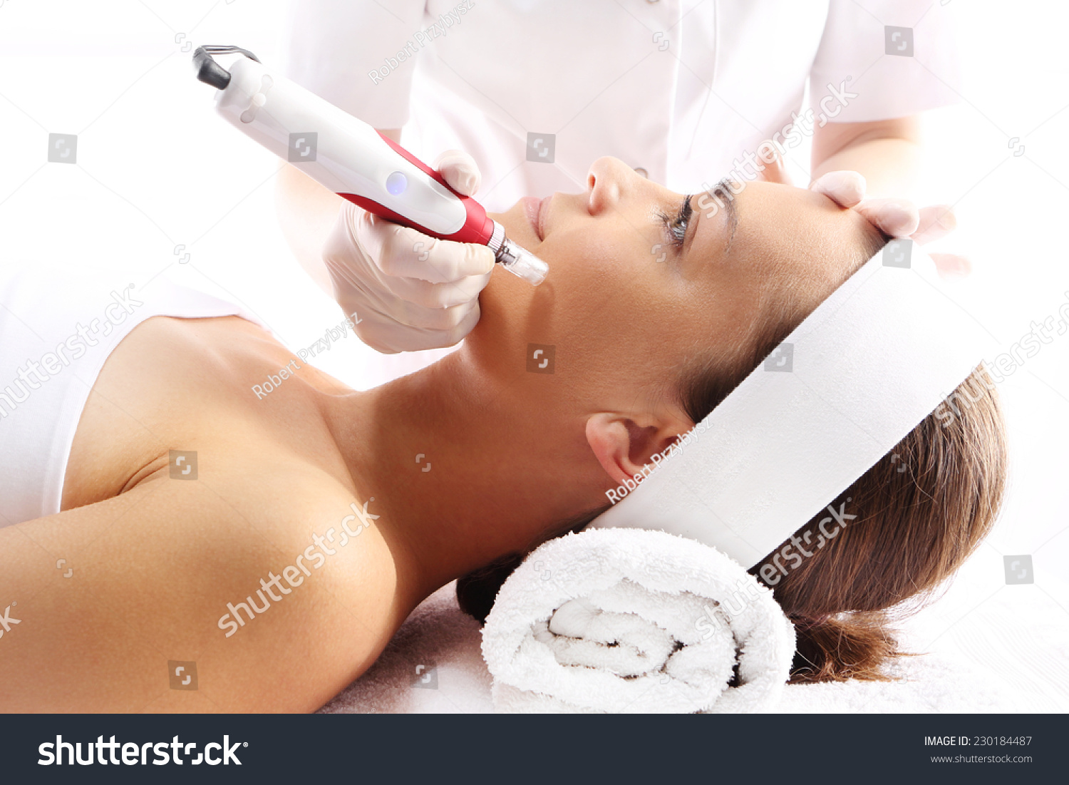 Needle mesotherapy.Beautician performs a needle mesotherapy treatment on a woman's face #230184487