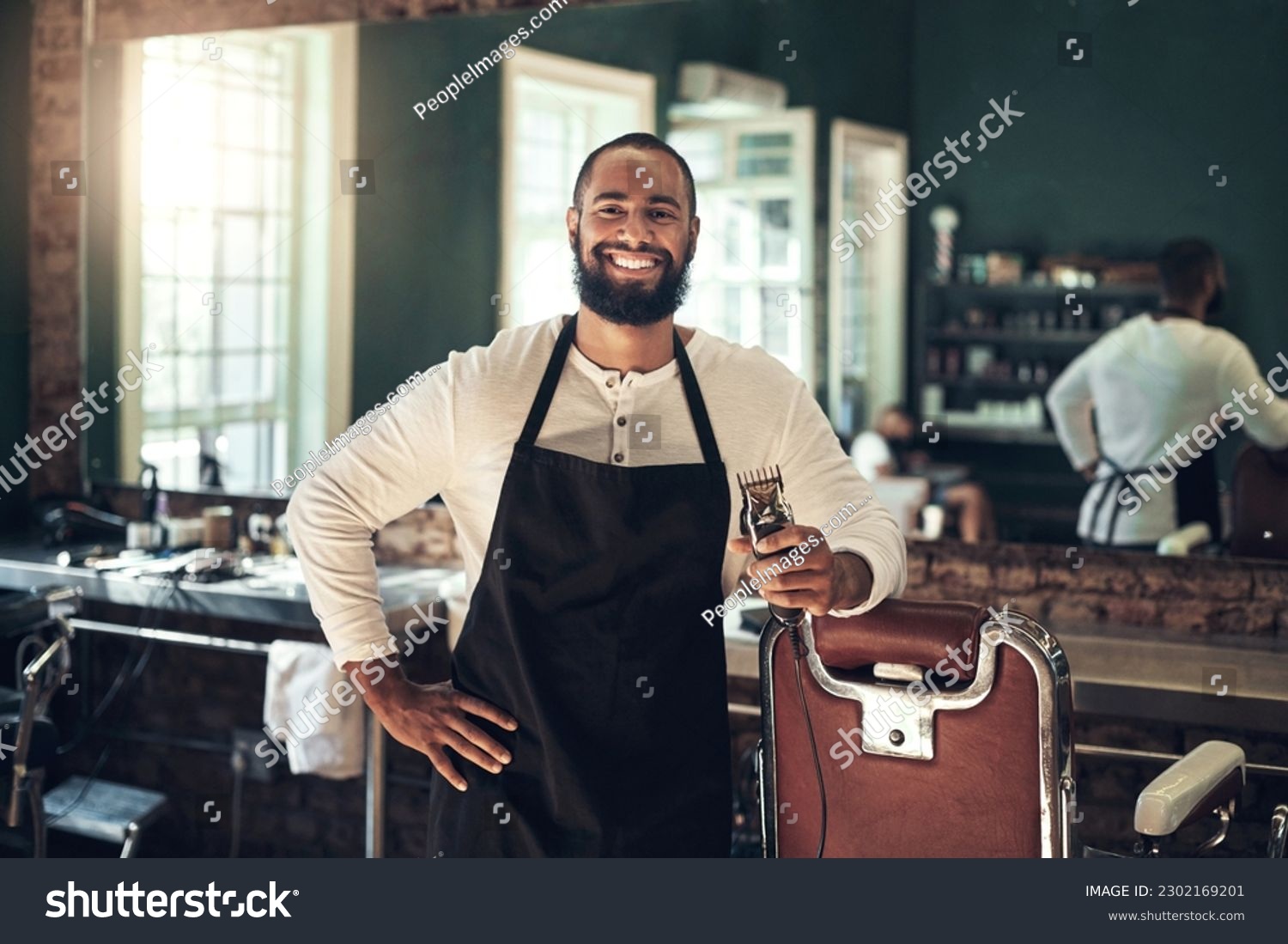 Barber shop, hair clipper and black man portrait of an entrepreneur with a smile. Salon, professional worker and male person face with happiness and proud from small business and beauty parlor #2302169201