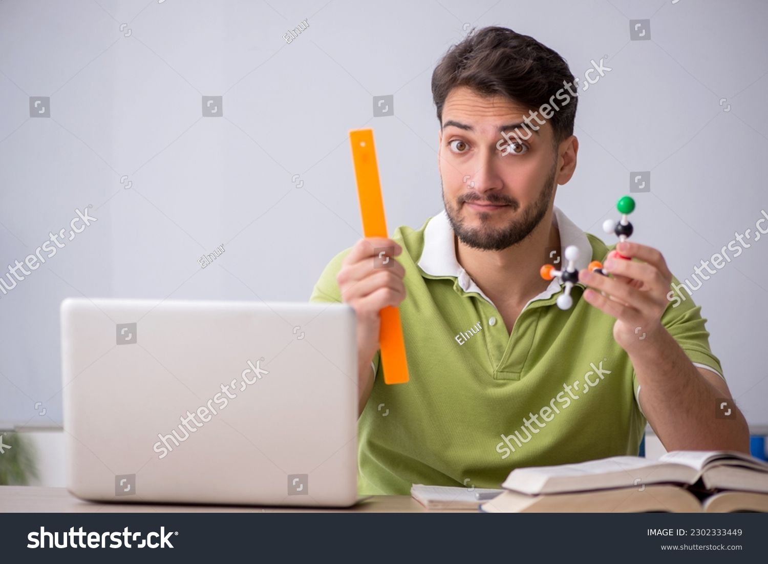 Young male student physicist sitting in the classroom #2302333449