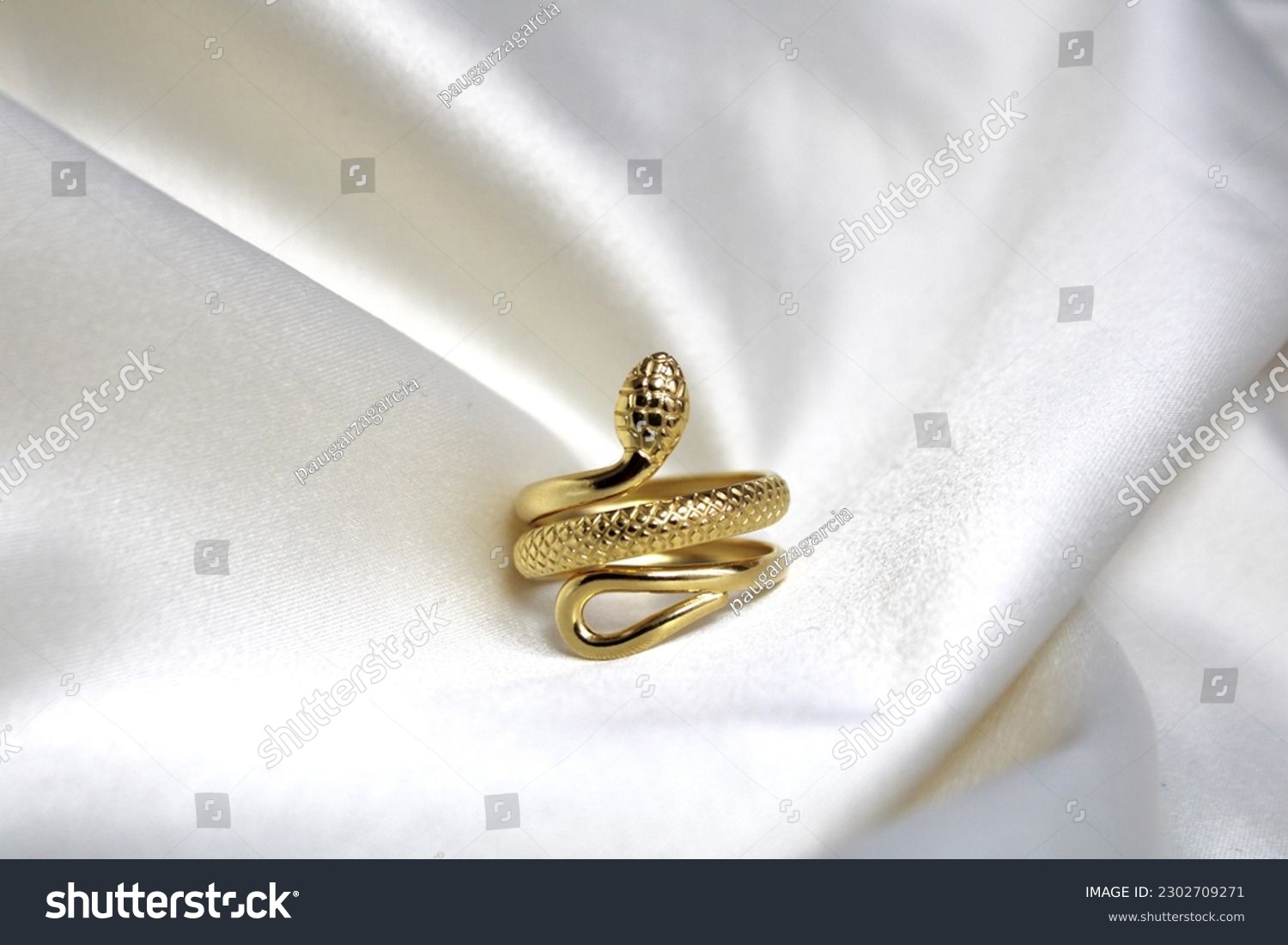 Cool golden snake ring with a white background #2302709271