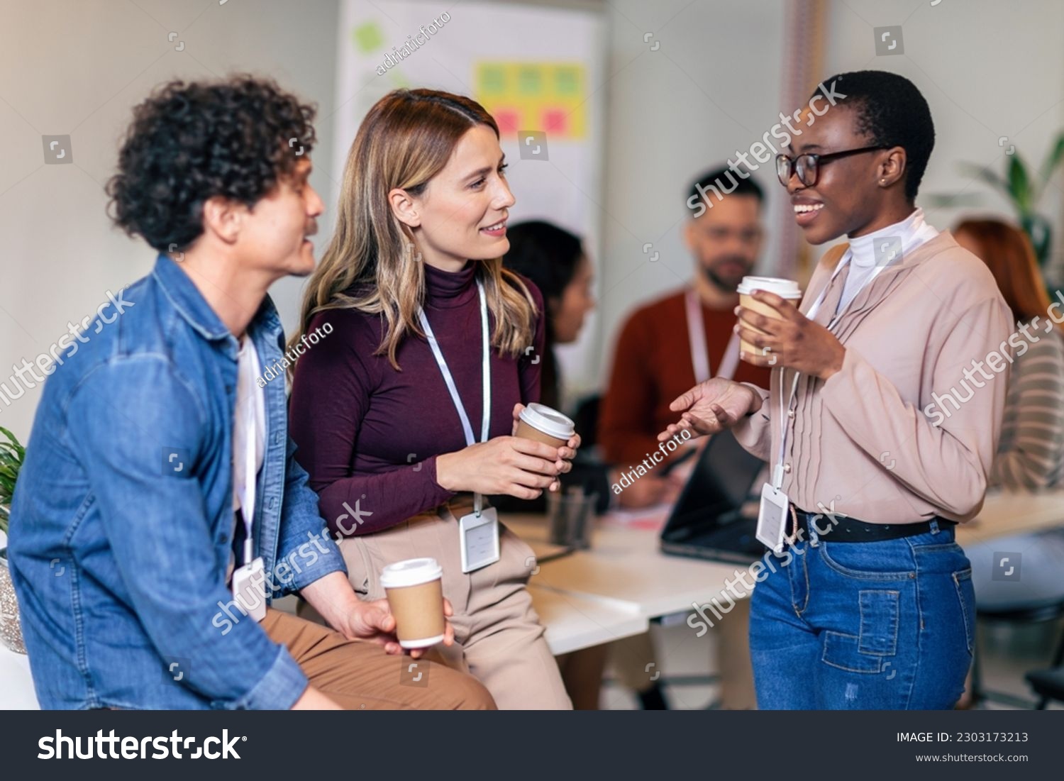 Happy diverse colleagues have fun at lunch break in office, smiling multiracial employees laugh and talk  drinking coffee #2303173213