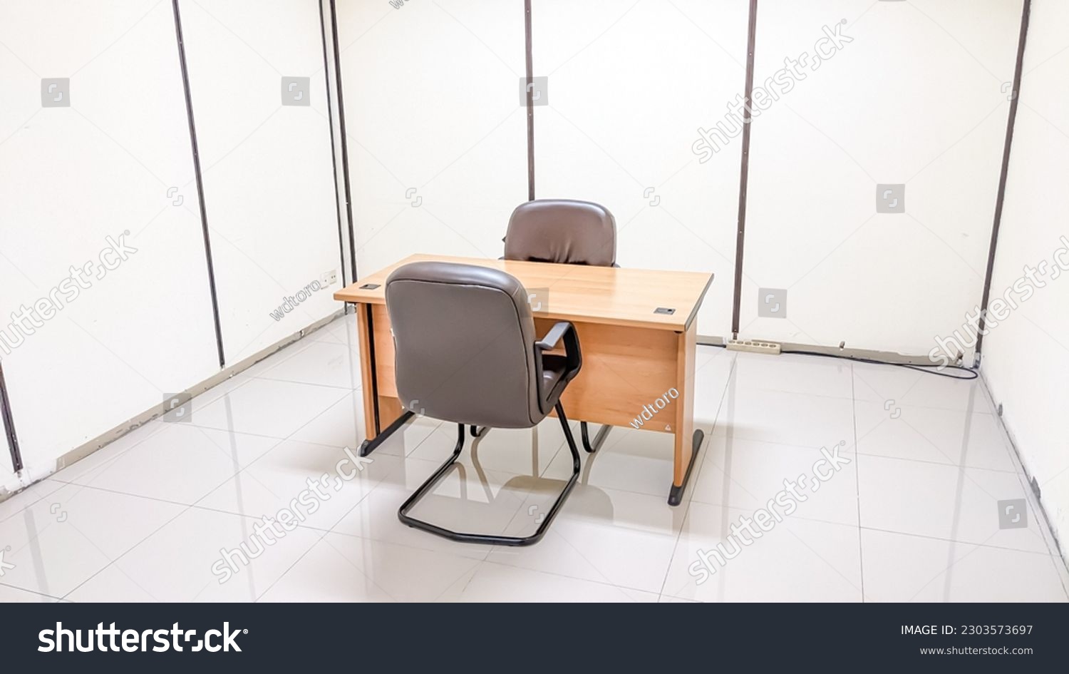 Wooden table furniture and two modern armchairs in the interrogation room #2303573697