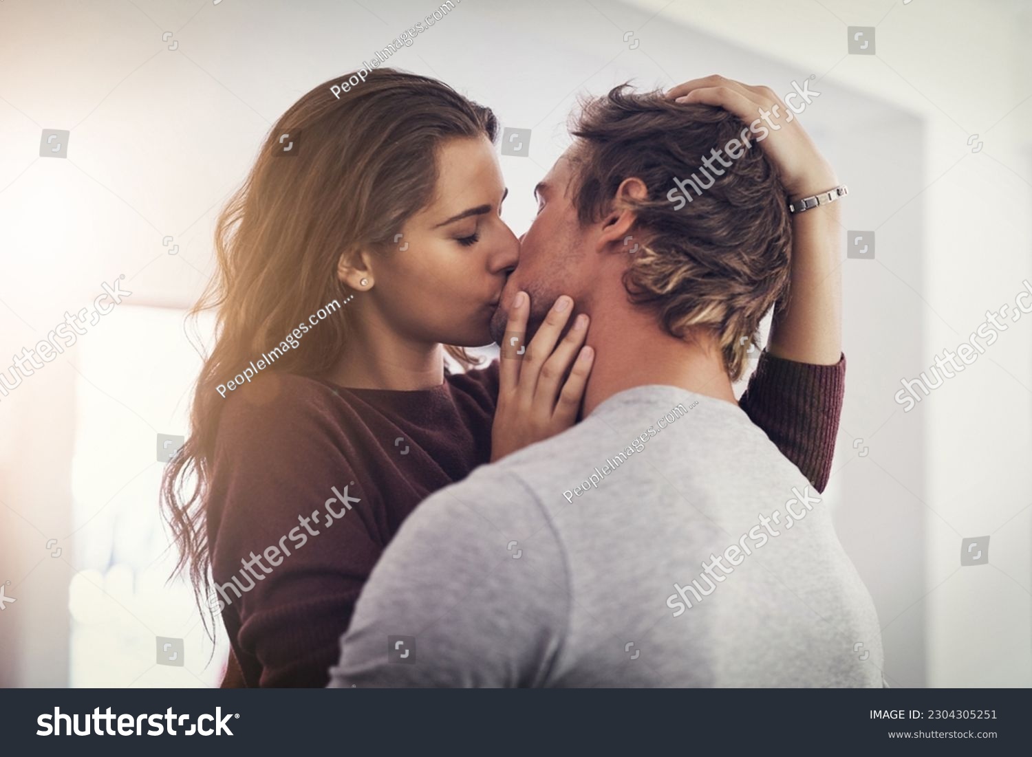 Couple, love and kissing in home for romantic bond, quality time and care together. Young man, woman and kiss for romance of lovers in happy relationship, intimate moment and passionate affection #2304305251