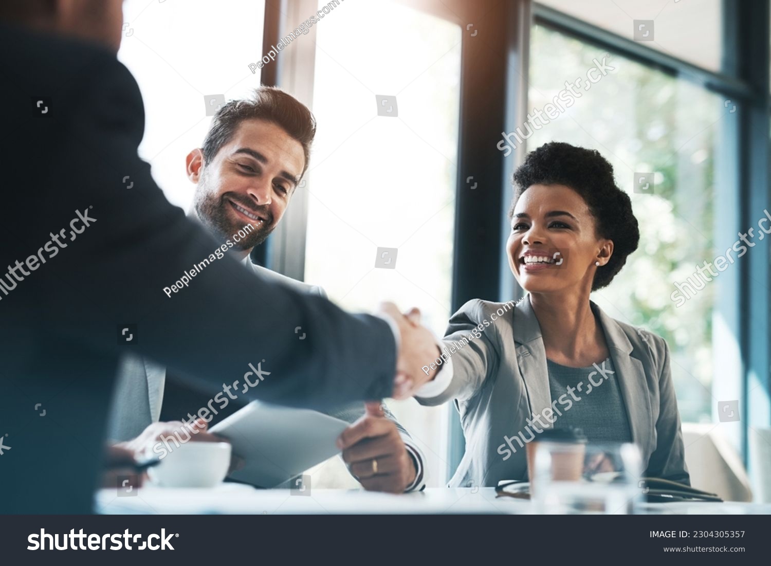 Business people, handshake and meeting for partnership, teamwork or collaboration in boardroom at office. Happy woman shaking hands in team recruiting, introduction or b2b agreement at the workplace #2304305357