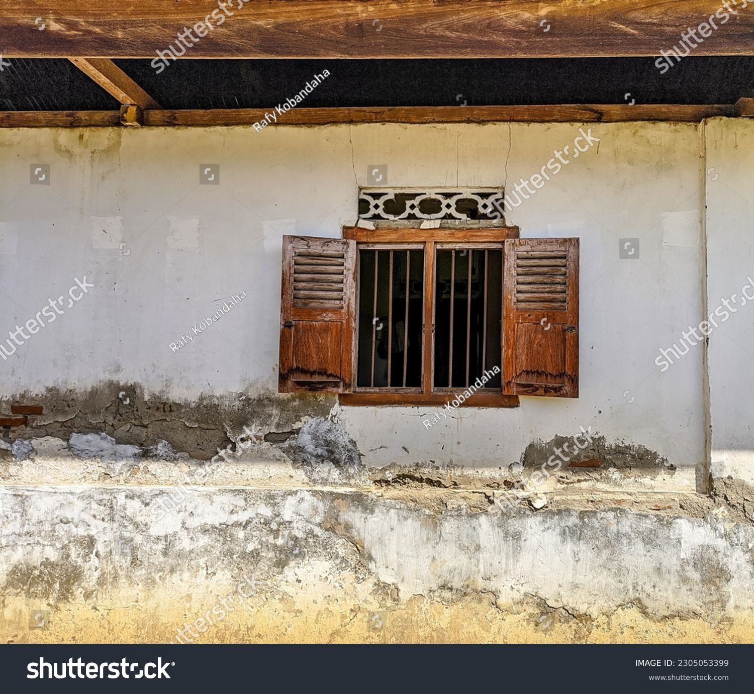Old wooden window that opens, country house with old cracked concrete #2305053399