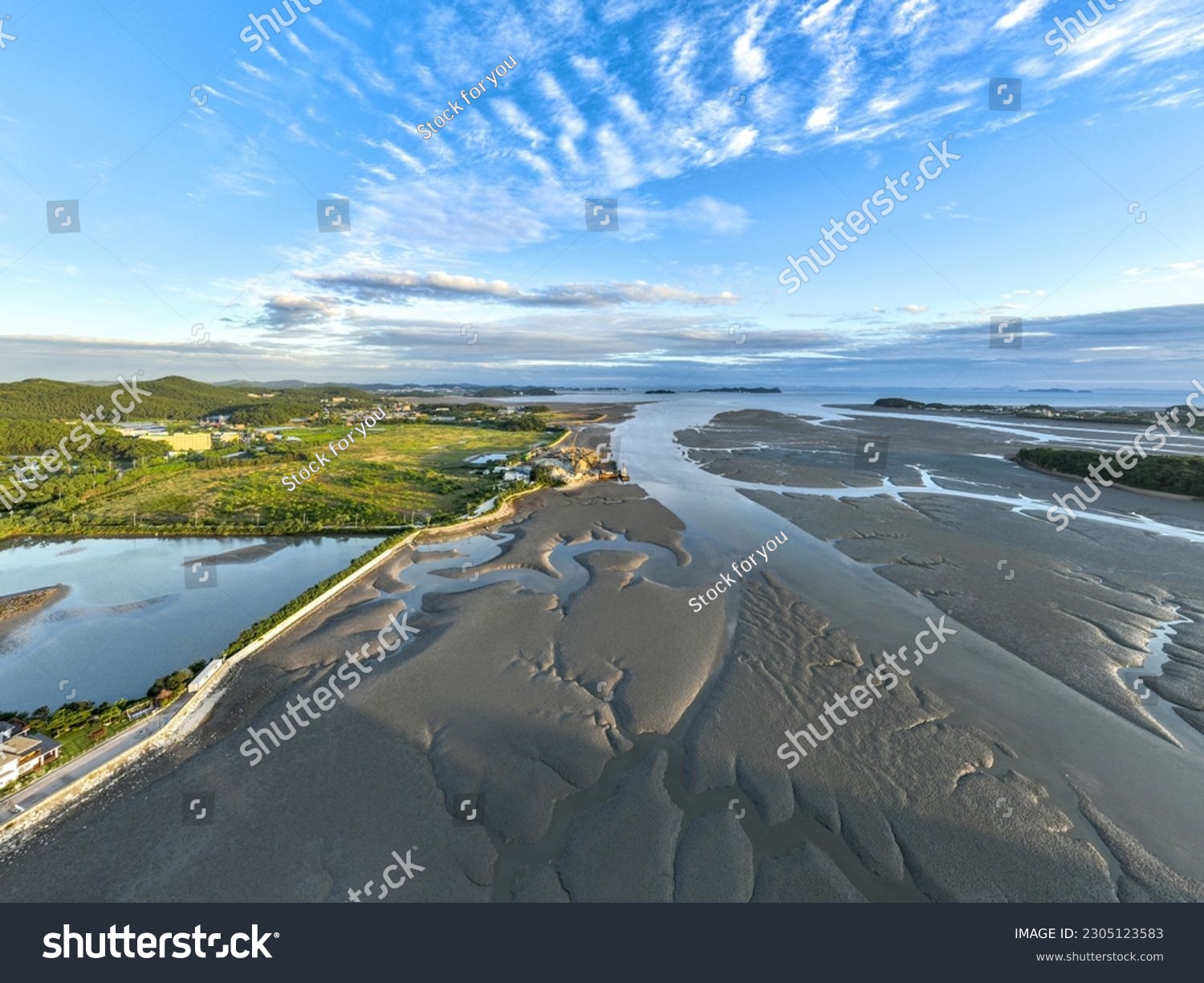 High angle and afternoon view of reclaimed land and mud flat with tidal channel at low tide sea at Seongamdo Island near Ansan-si, Gyeonggi-do, South Korea
 #2305123583