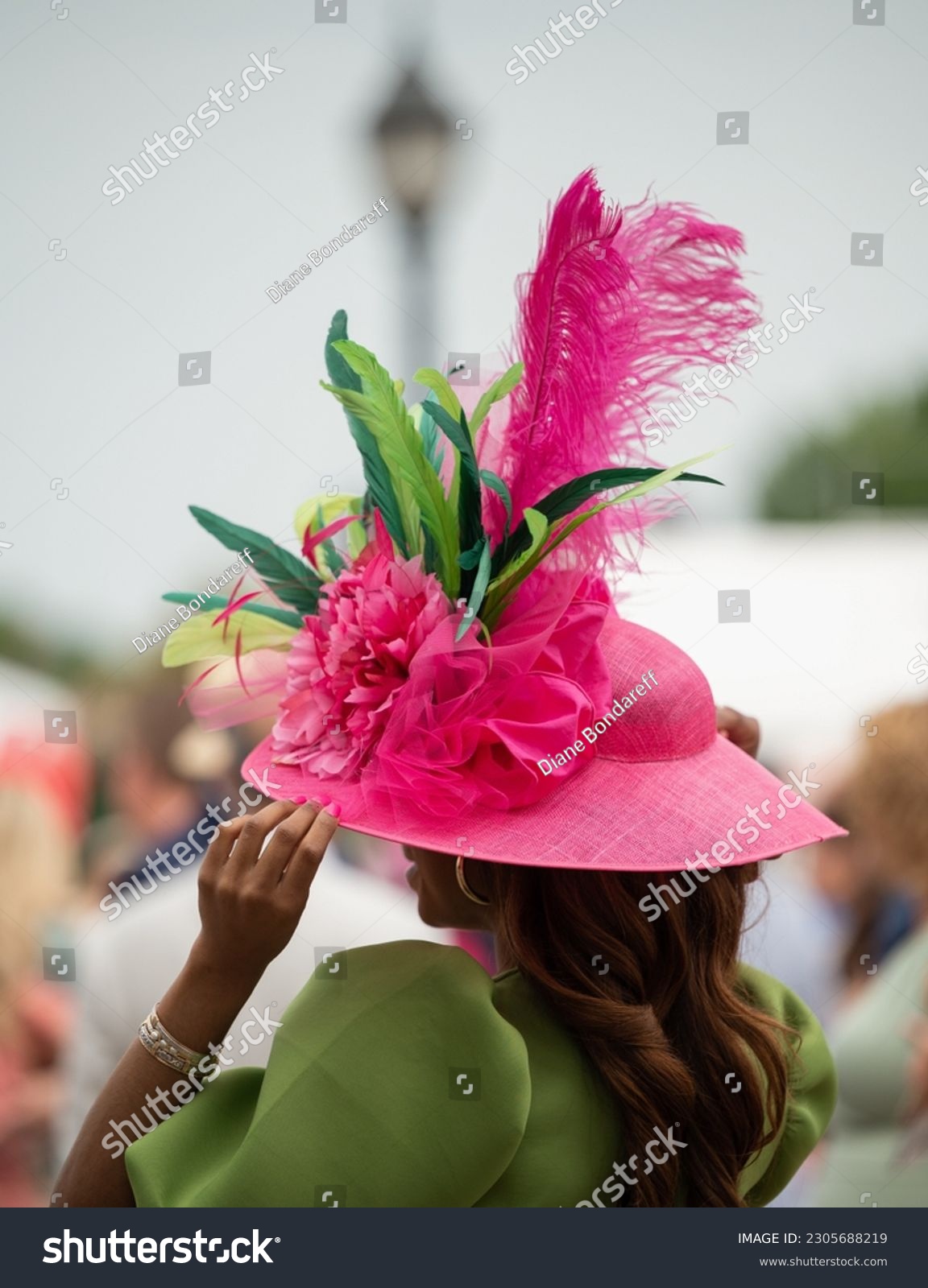 Elegant hats and fancy attire at the horse races  #2305688219