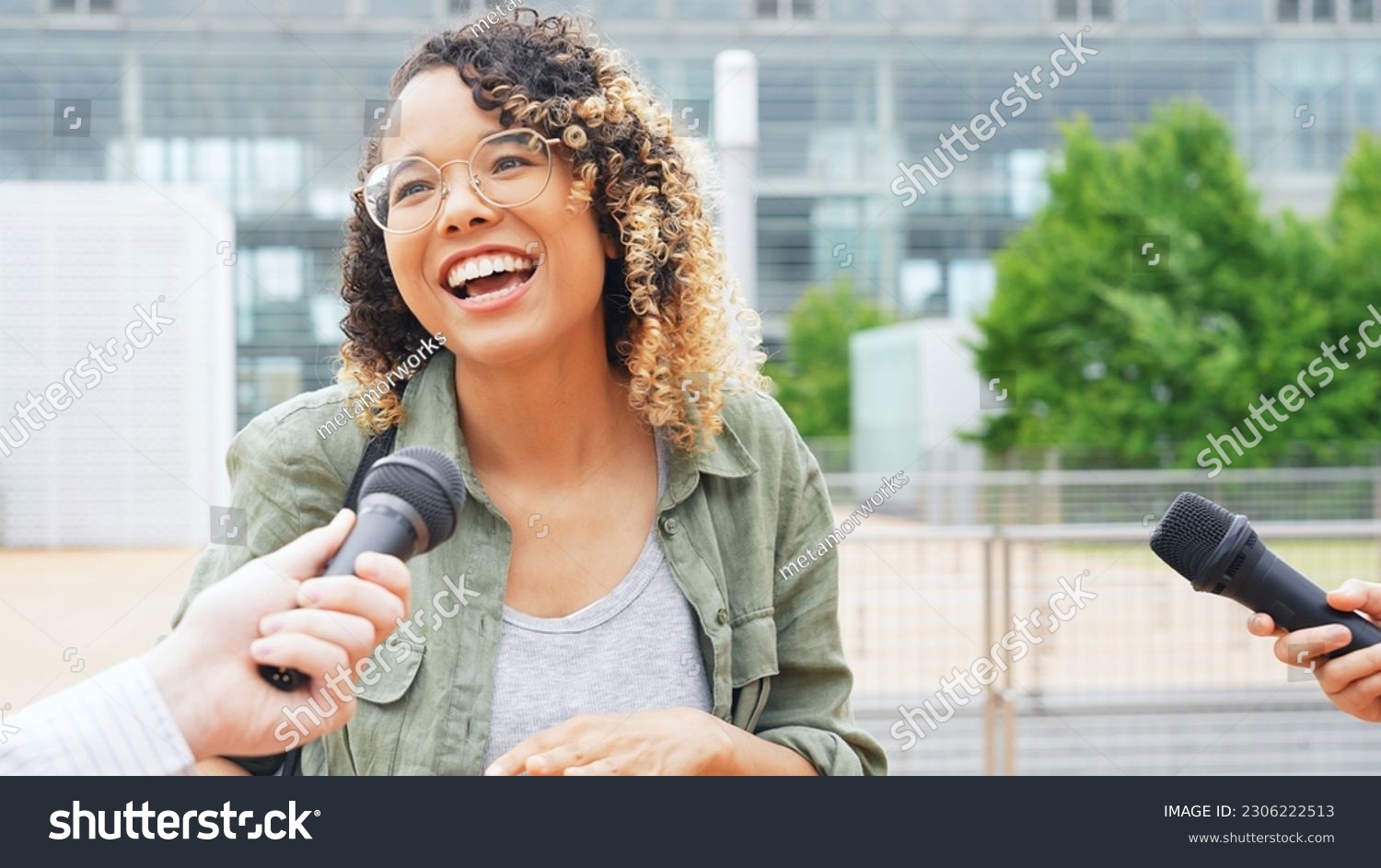 African woman being interviewed on the street by the media. #2306222513