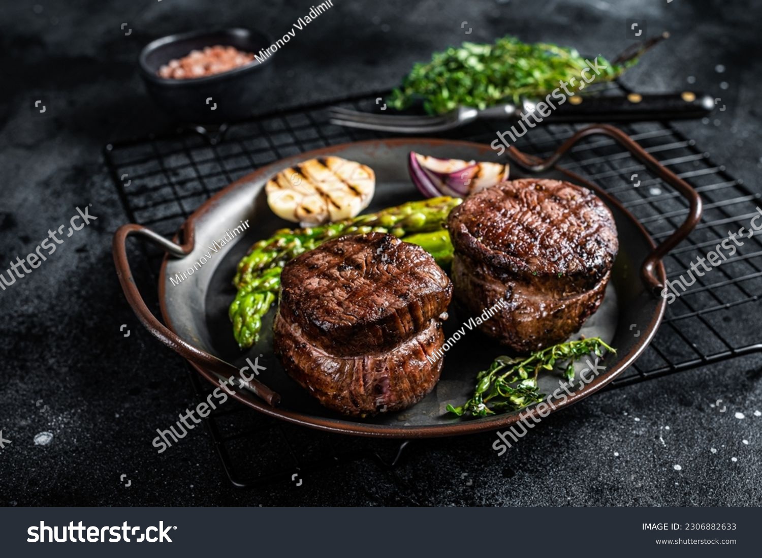 Grilled Fillet Mignon Steak with roasted asparagus. Black background. Top view. #2306882633