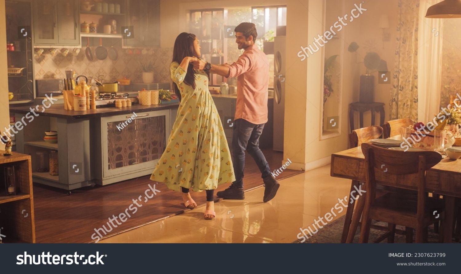 Young Couple Dancing and Having Fun in the Kitchen: Enjoying Each Other's Company and Playfully Moving to Music. With Joyful Laughter and Smiles, they Embrace the Music and Dance #2307623799