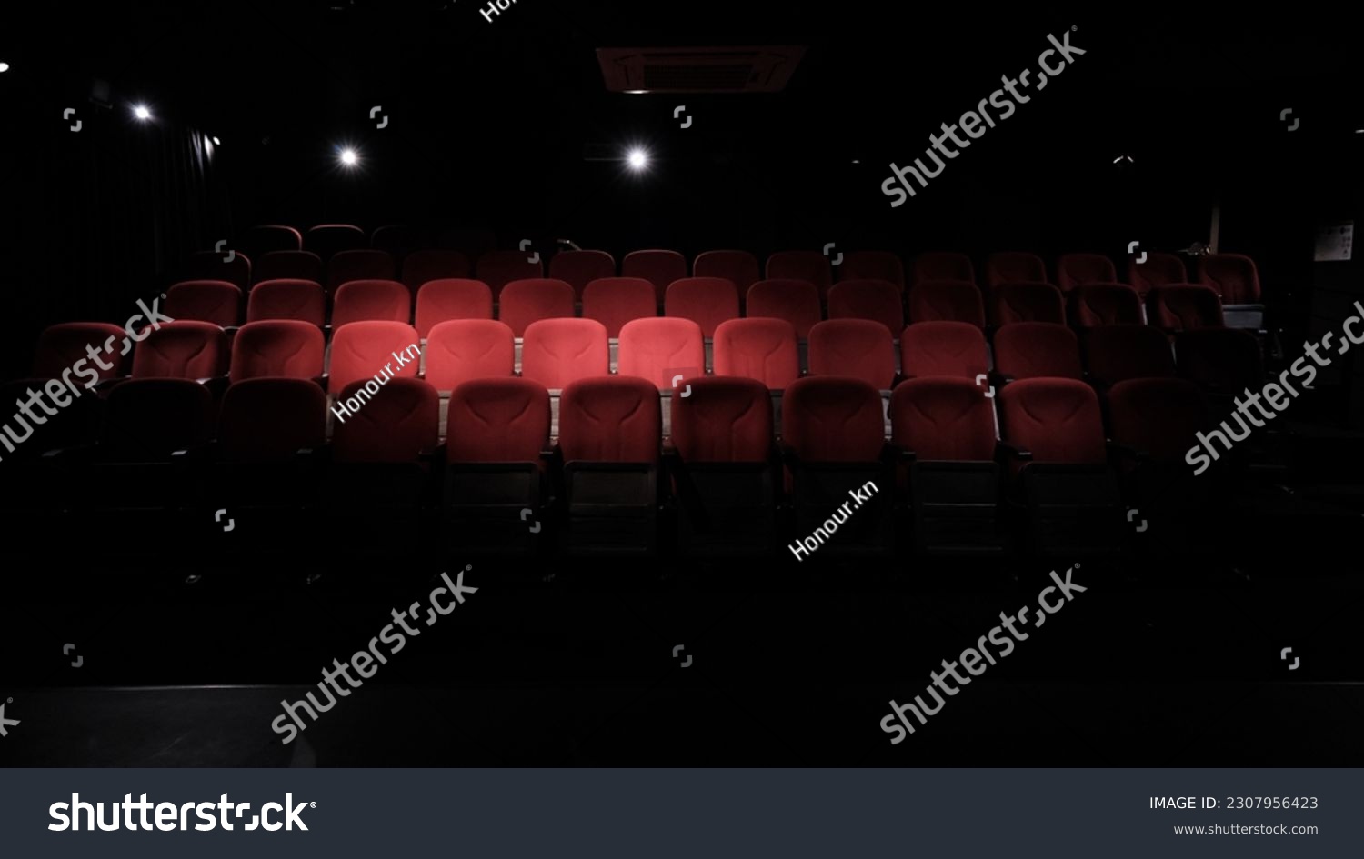 stage light hitting red cloth seats in theater , movie theater, cinema seats #2307956423