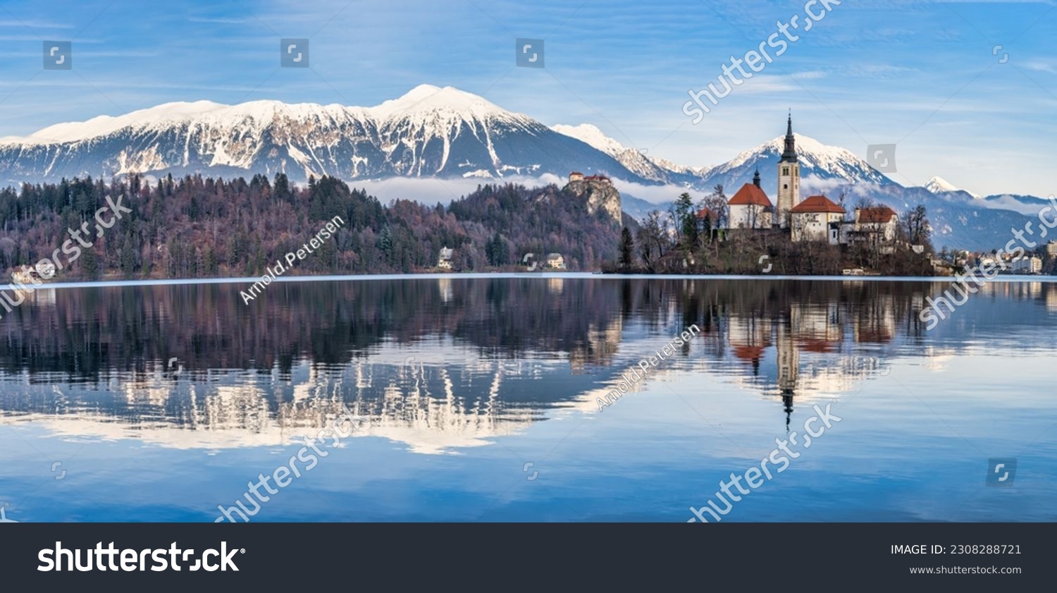 Panorama shot of lake Bled island church, bled castle and snow peak mountains during a winter afternoon, Bled, Slovenia #2308288721