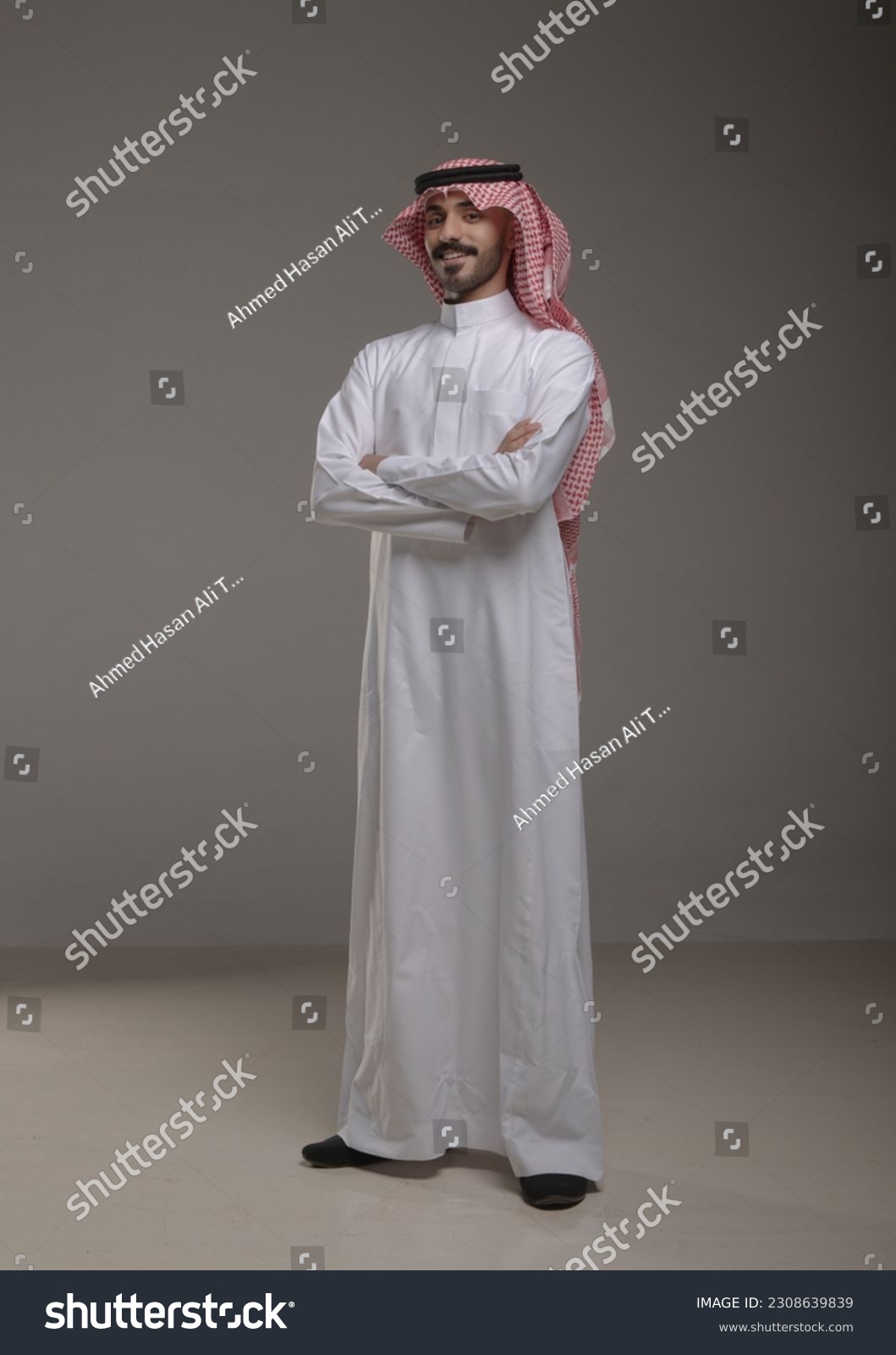 A saudi character wearing thob standing on withe background #2308639839