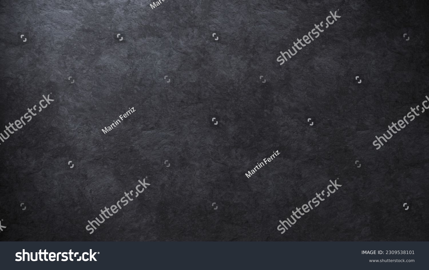 Elegant background texture of a dark stone surface softly lit from one side #2309538101