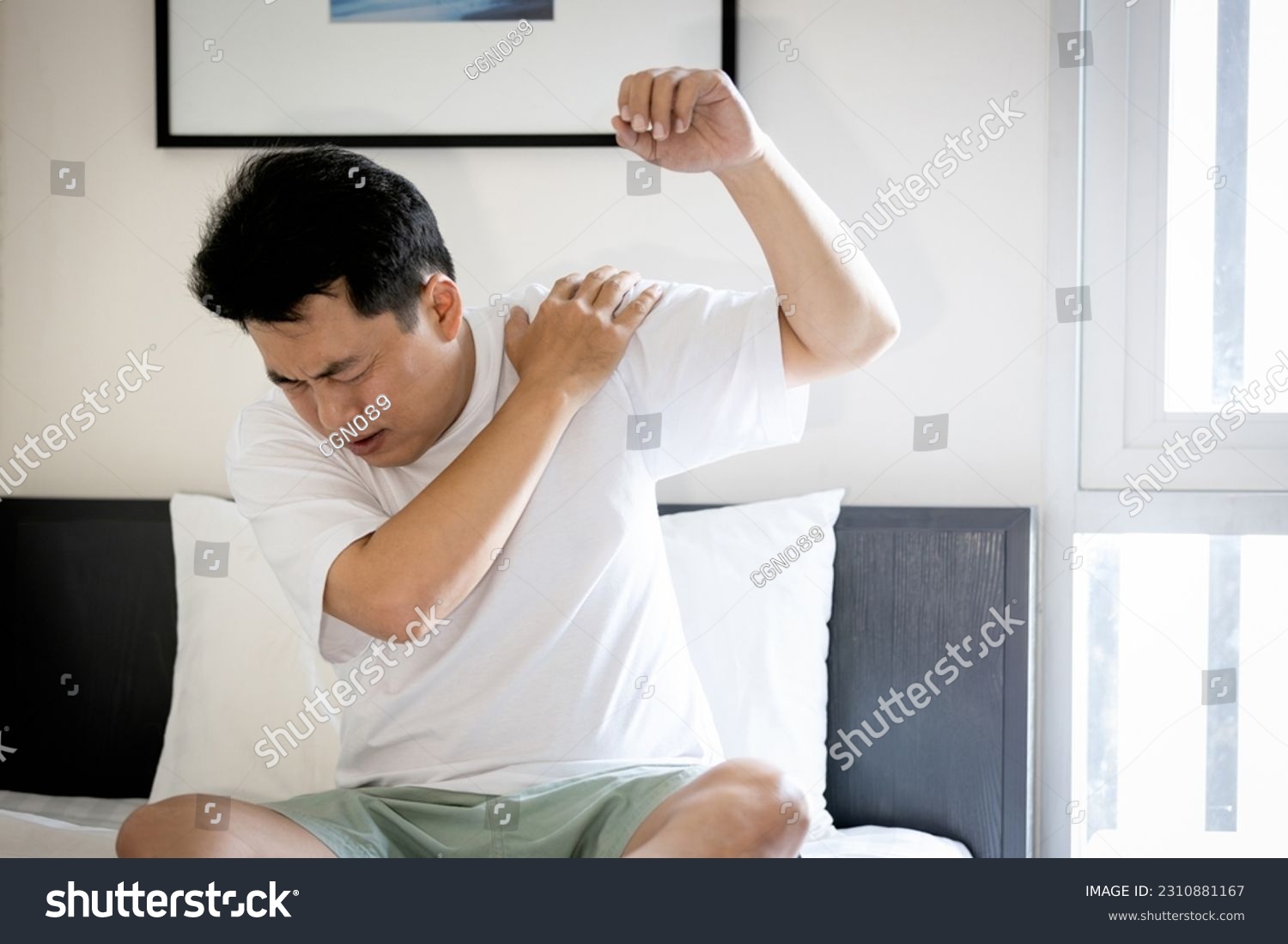 Asian middle aged man suffering from frozen shoulder,pain and stiffness,unable to move,difficulty lifting his arm,male people with calcific tendonitis or shoulder injuries,health care,medical concept #2310881167