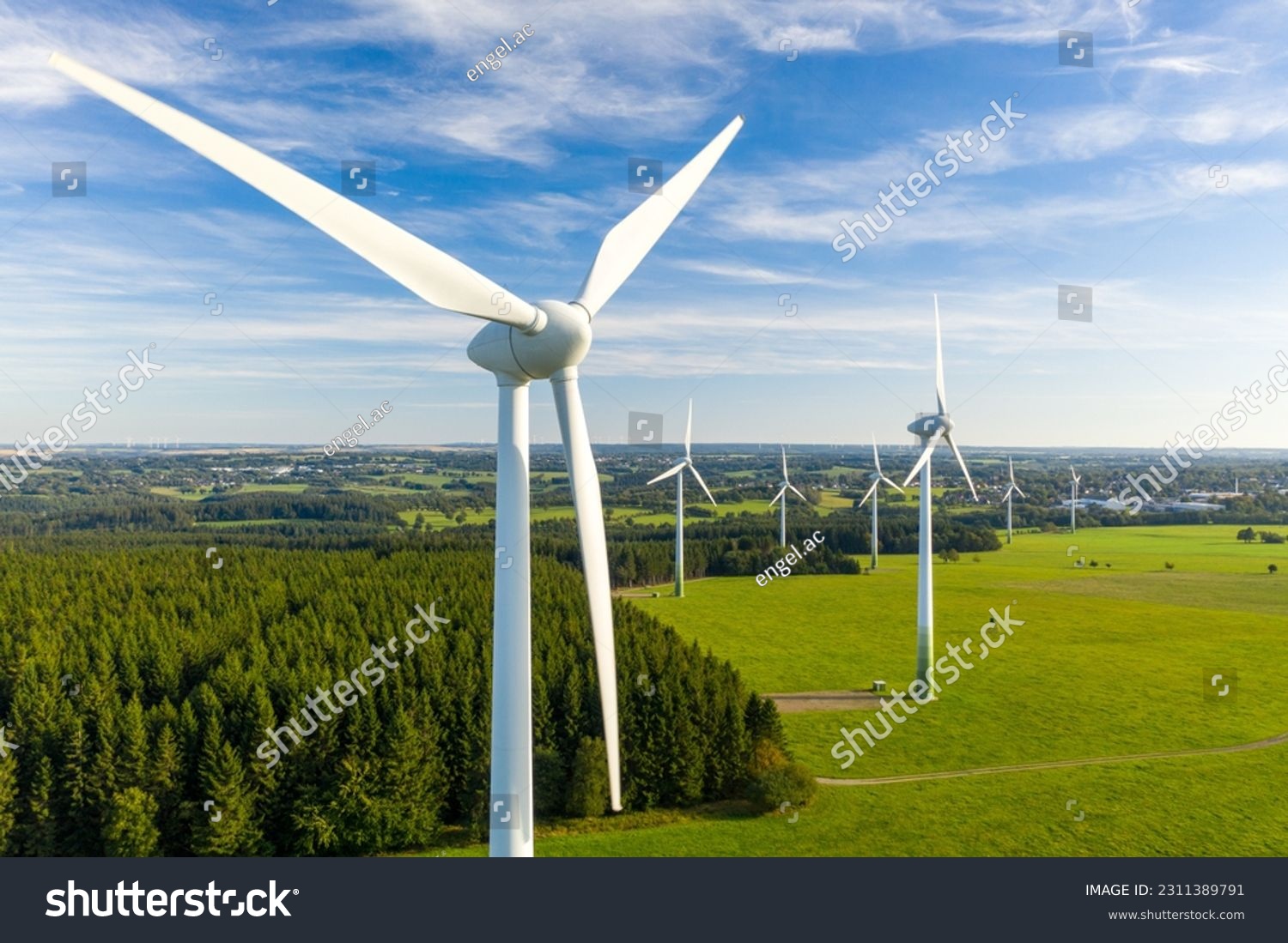 Windmills in a rural area during sunset #2311389791