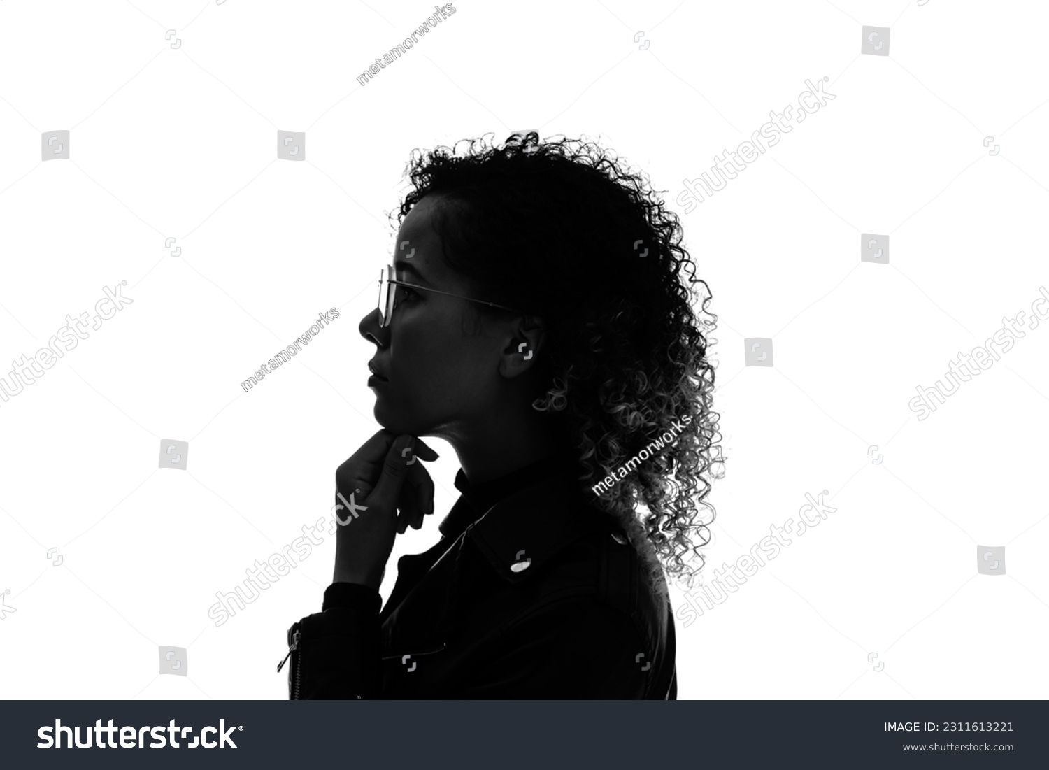 Profile silhouette of thinking black woman in studio shot. #2311613221