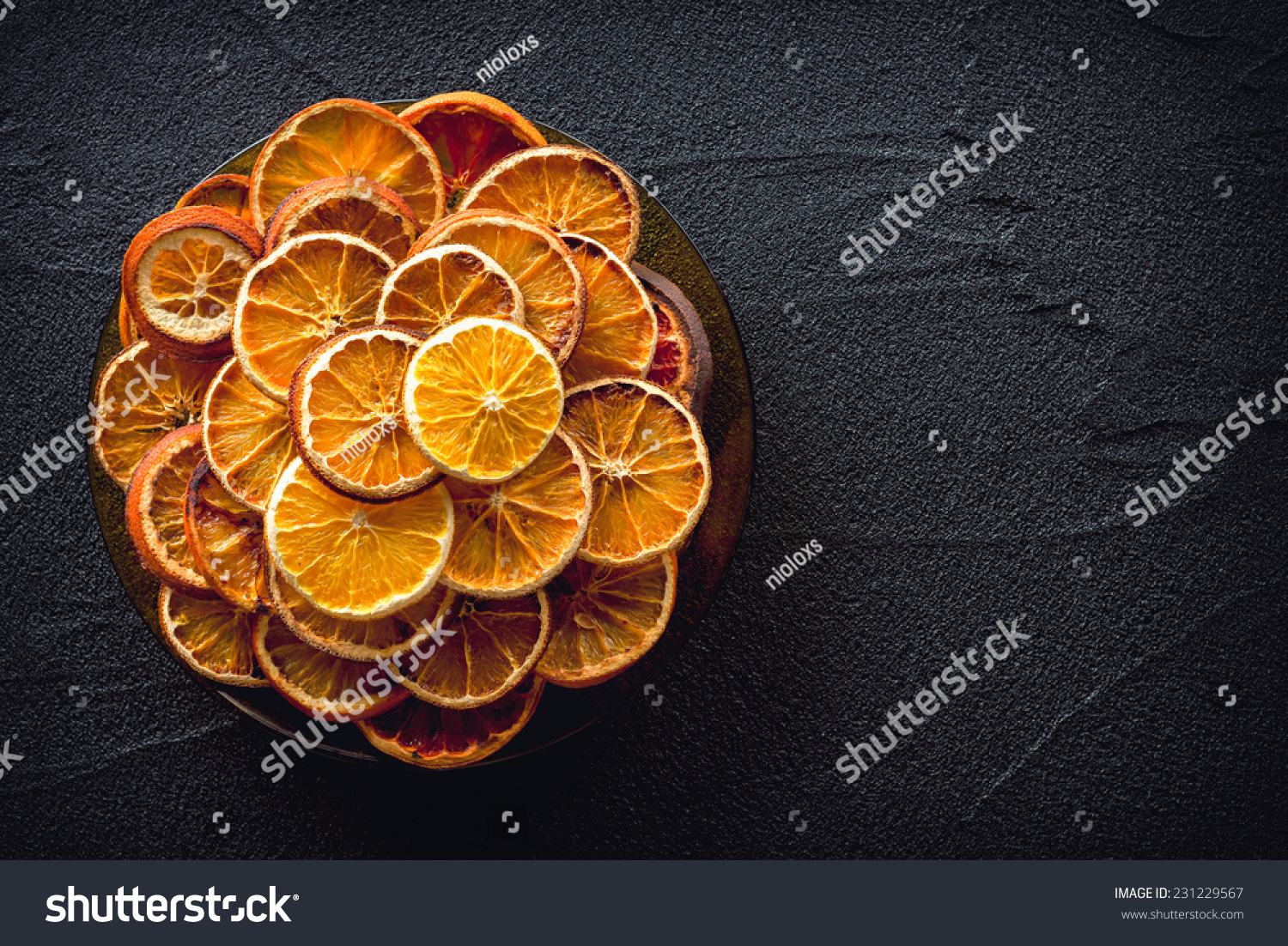 Dried oranges on black stone background #231229567