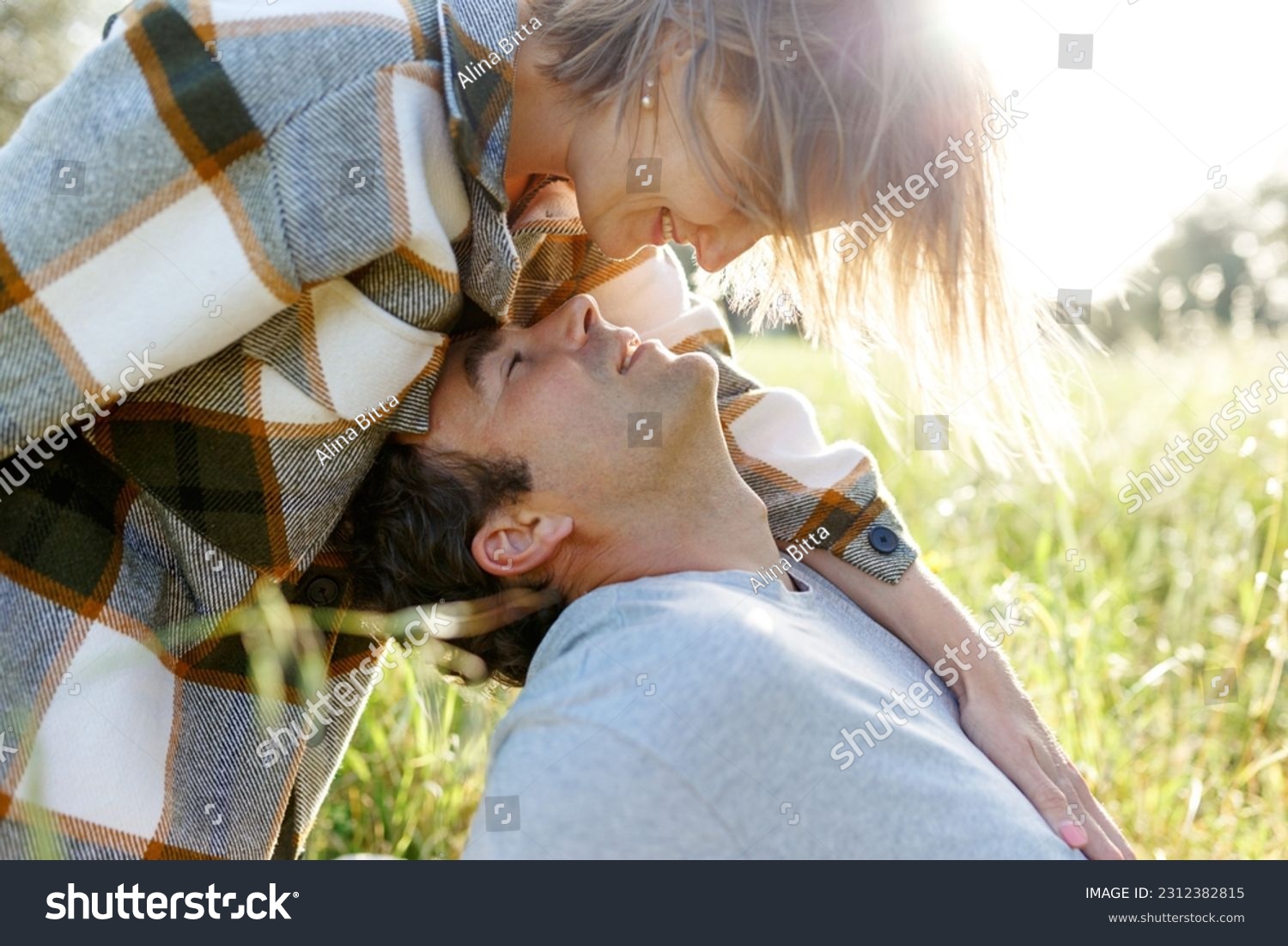 Close up portrait man and woman laughing together.Romantic affectionate couple on a holiday.Couple embracing and smiling. Sunset sunshine . #2312382815