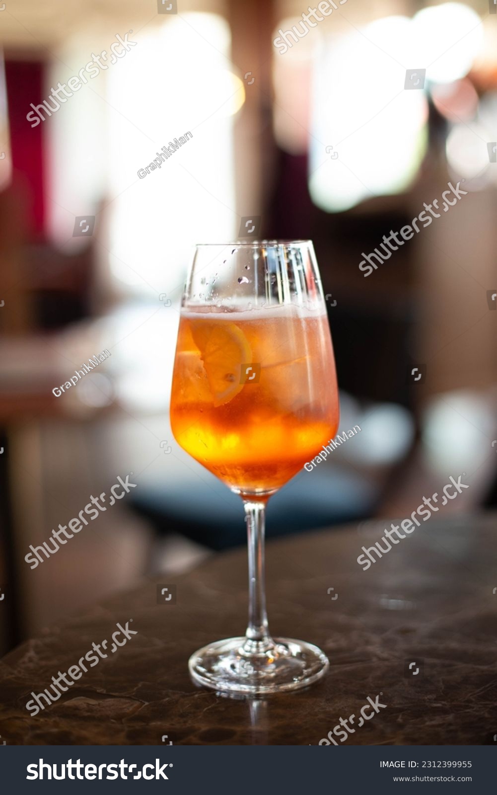 glass of aperol spritz cocktail on colorful background #2312399955