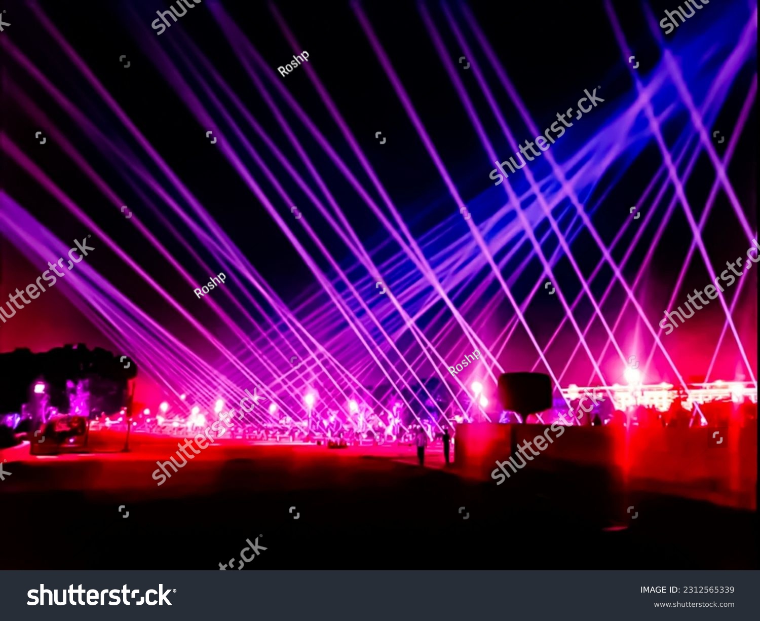 Purple laser neon beams club stage Luxury entertainment with audience silhouettes in nightclub event, Beams and rays shining colorful lights. #2312565339
