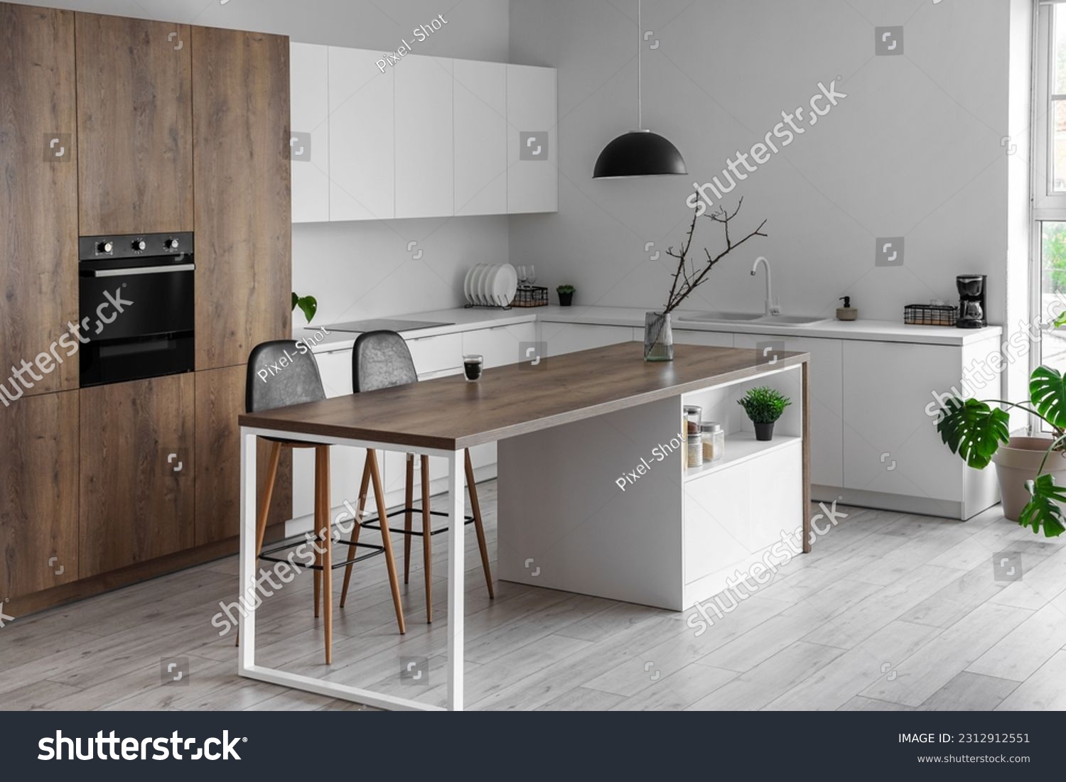 Interior of modern kitchen with island, built-in oven and white counters #2312912551