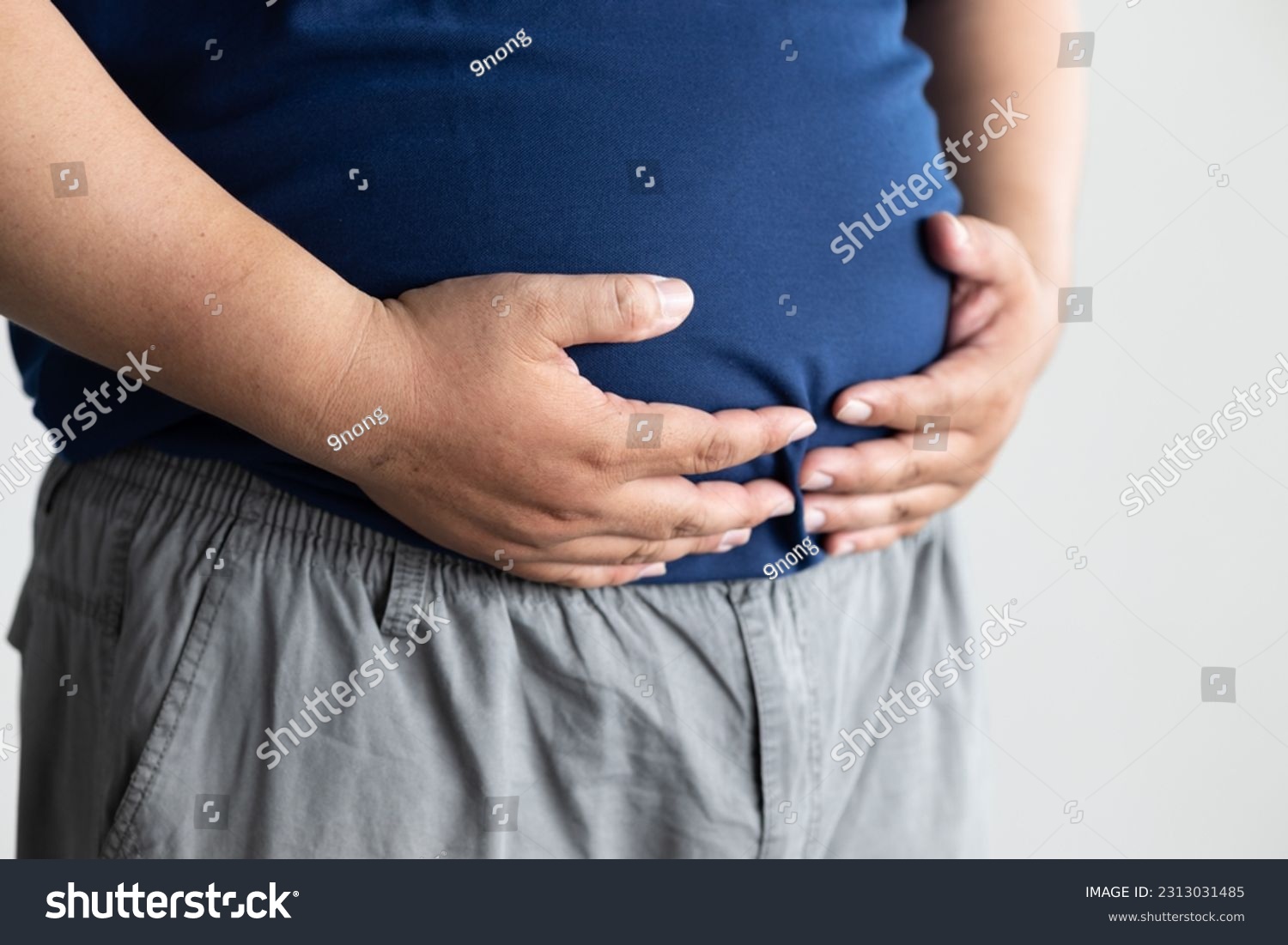 fat middle aged old asian man belly, concept of overweight, dad bod, over eating, obesity, unhealthy lifestyle #2313031485
