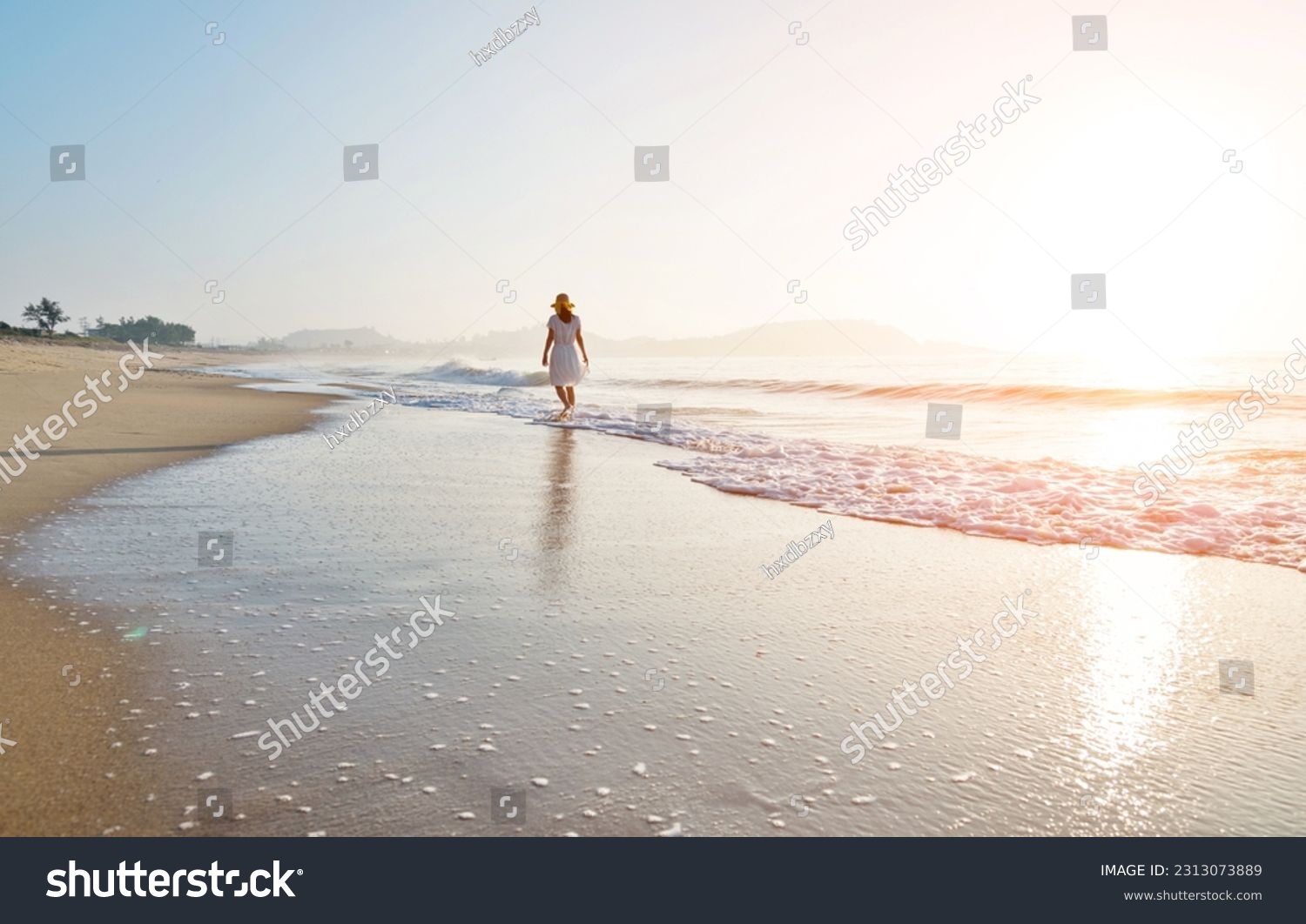 Young woman walking at the beach. #2313073889