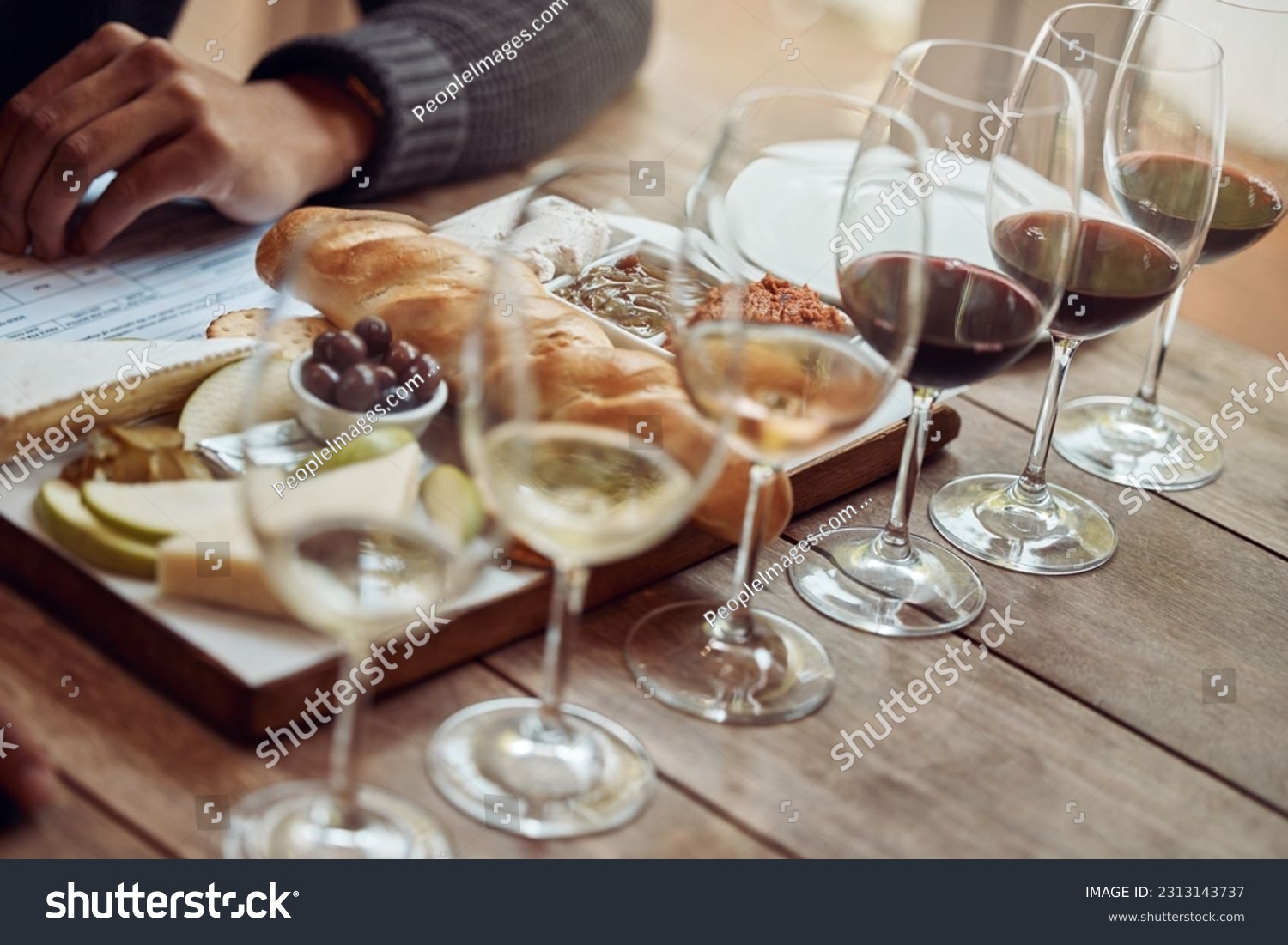 Wine tasting, cheese board and winery restaurant with alcohol and glass for customer. Eating, drink and person with rich wines and food pairing in a fine dining and luxury snack experience alone #2313143737