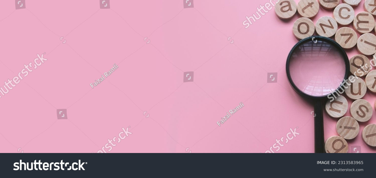 Concept of learning english, searching for word, and information. English alphabet letter and magnifying glass. Pink background with copy space. #2313583965